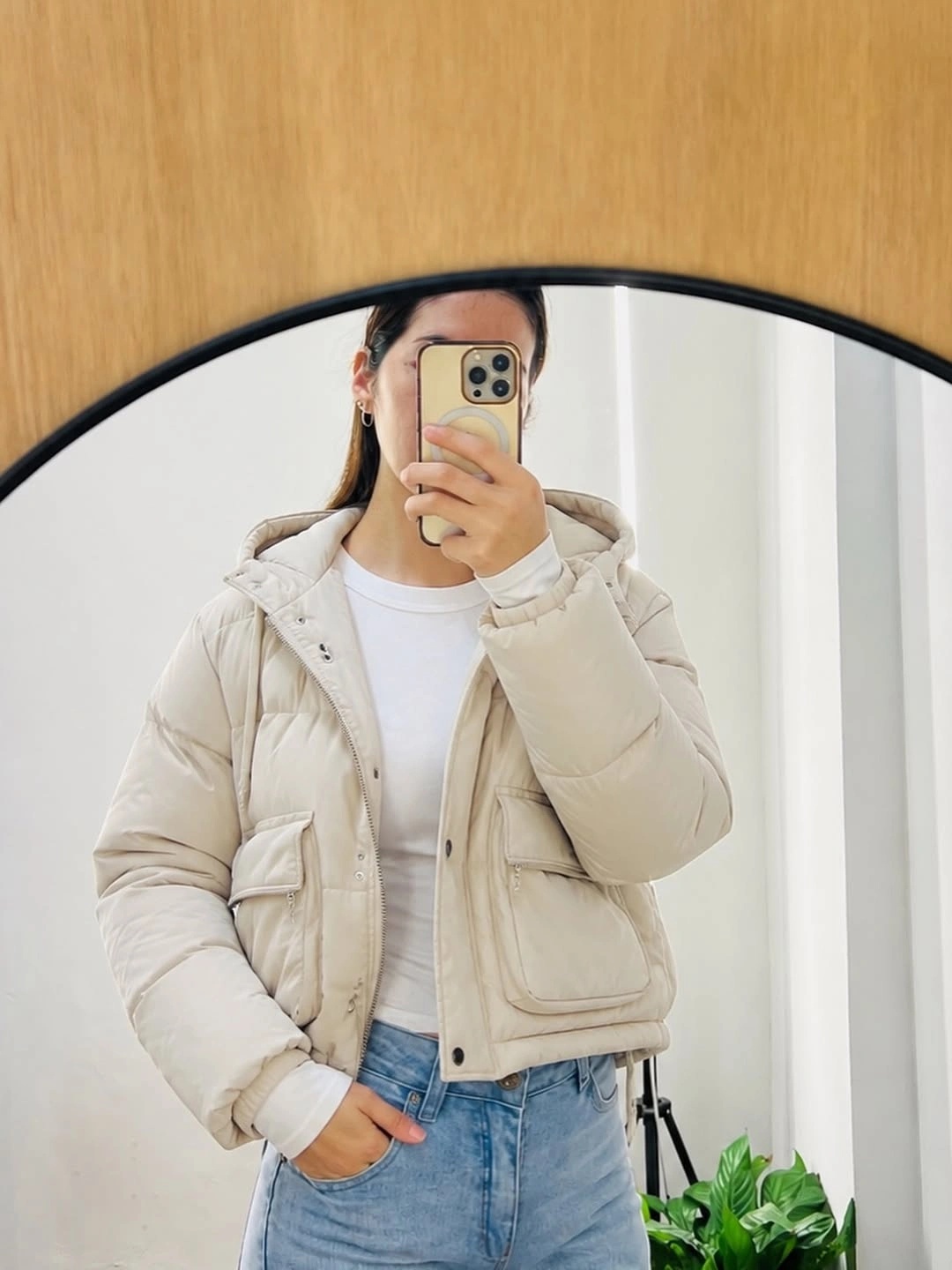 Cream cropped puffer jacket with white top and blue jeans