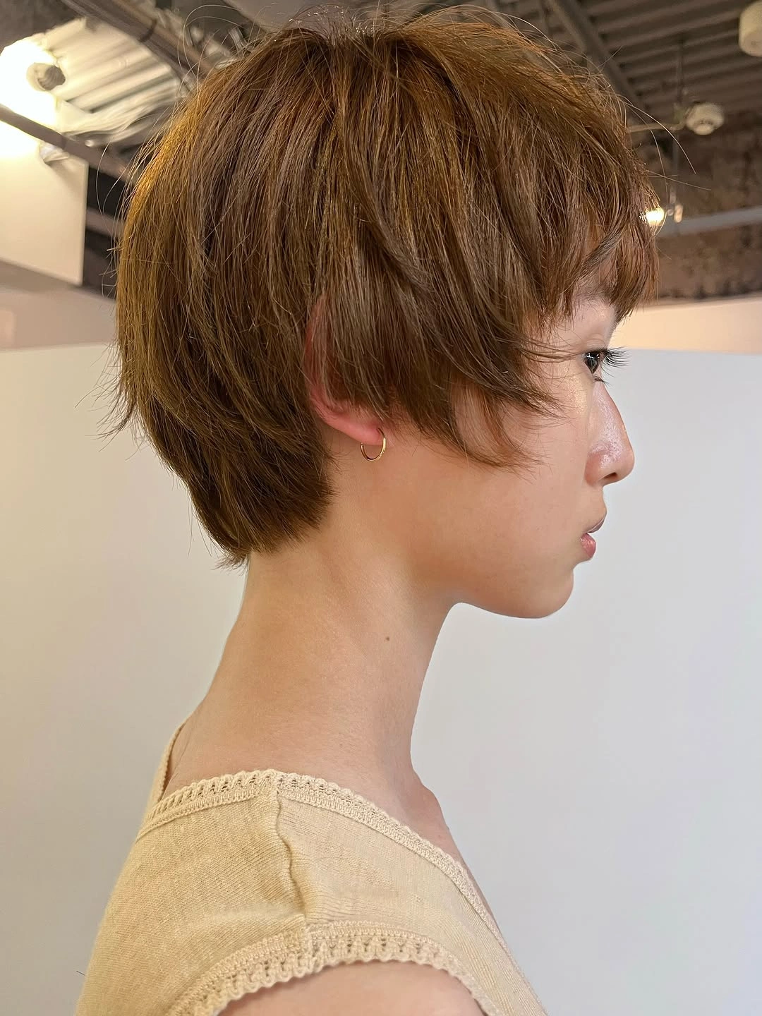 Very short brown hair with blunt micro fringe and rounded crown