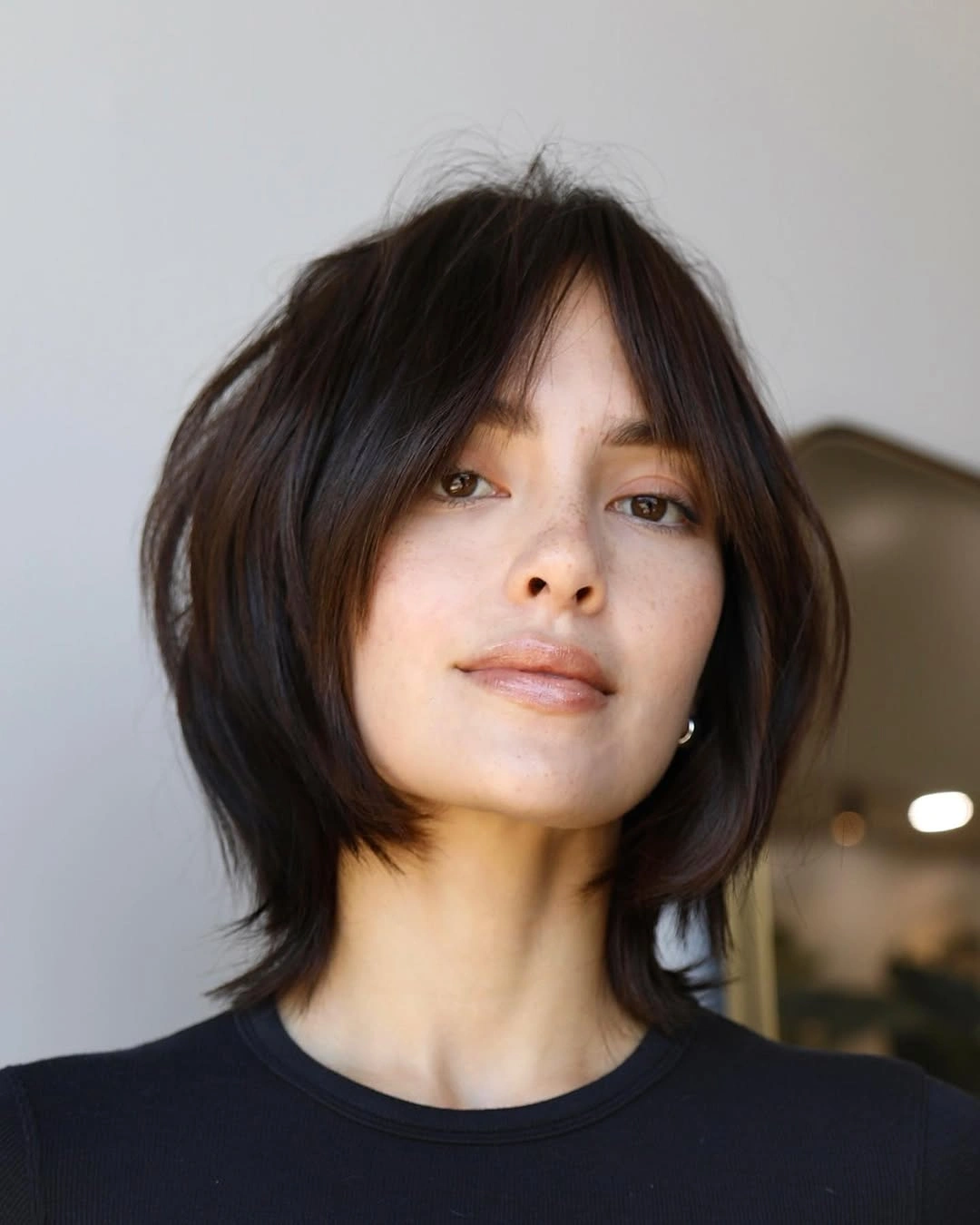 Long brunette hair with repeated curved face framing layers