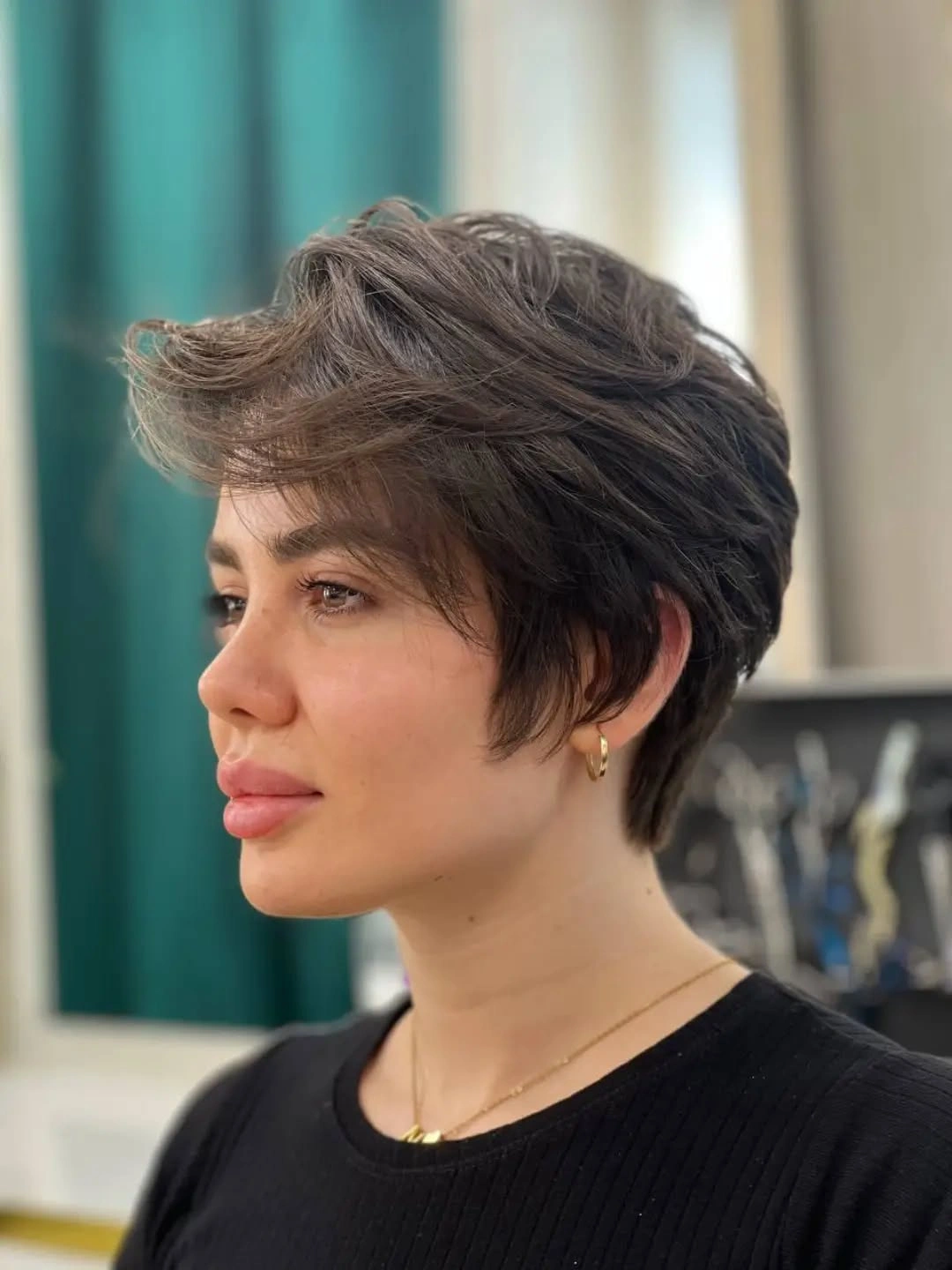 Short dark hair with deep side part and rounded jaw length ends