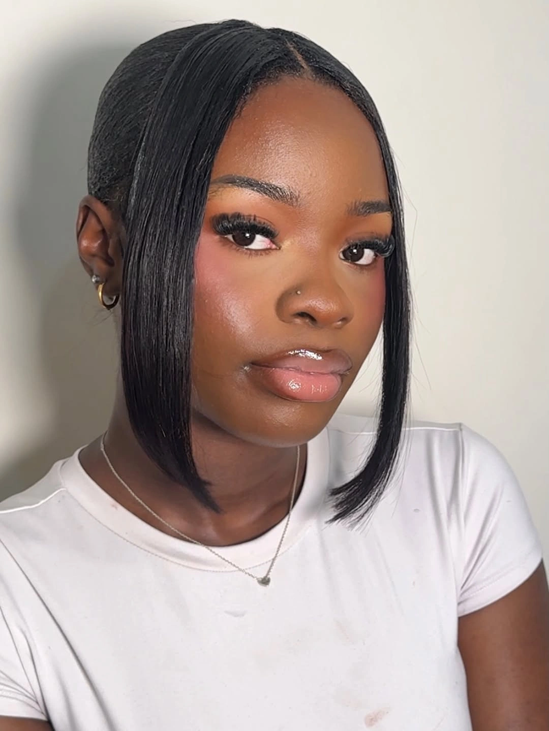 Sleek black asymmetrical bob with one side tucked