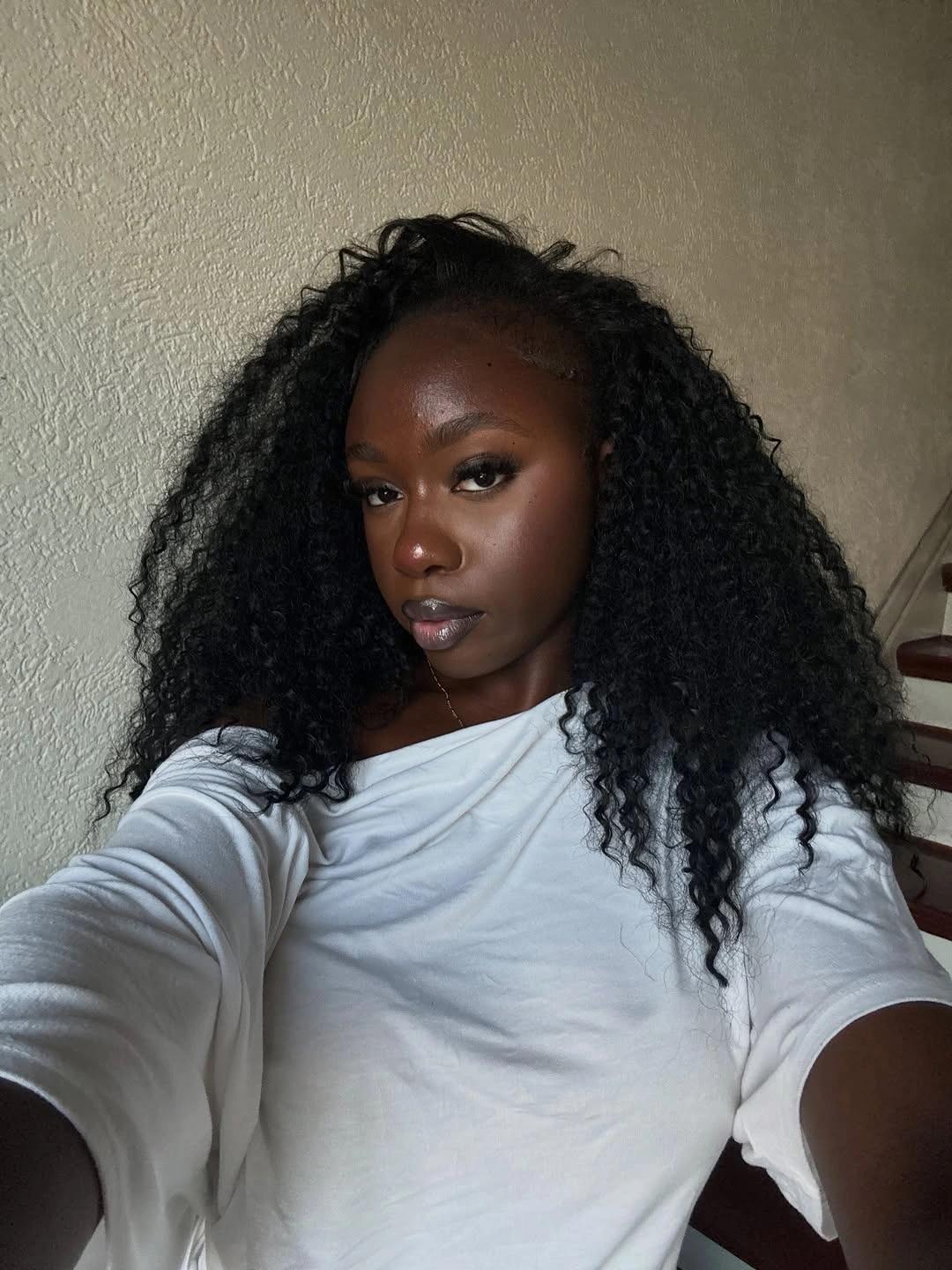 Long dark curls falling heavily to one side