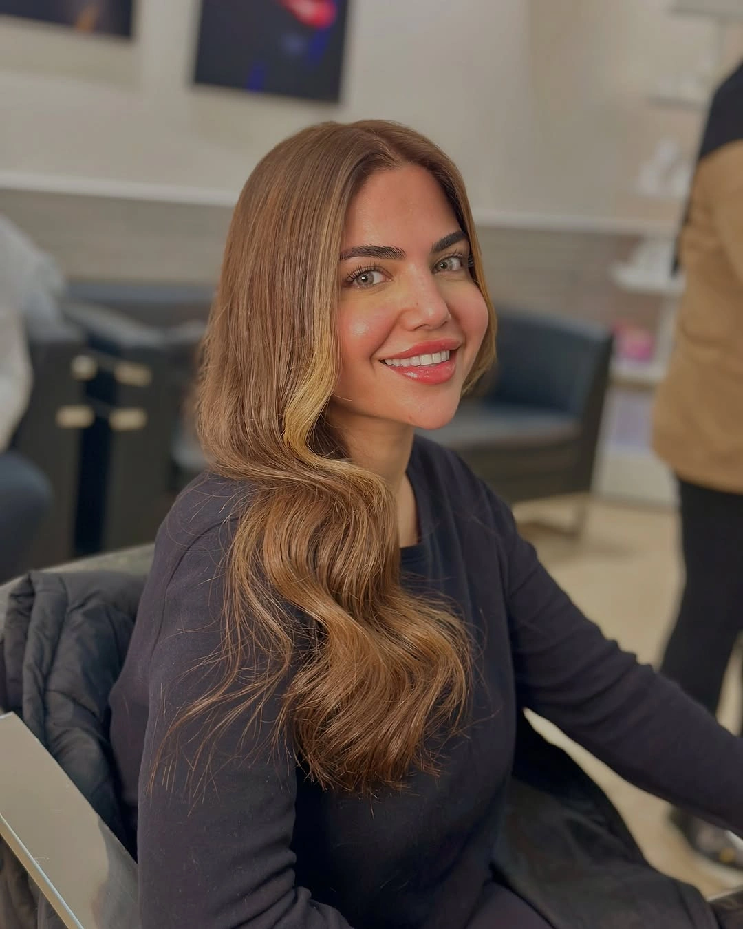 Long warm brown side-parted waves over one shoulder