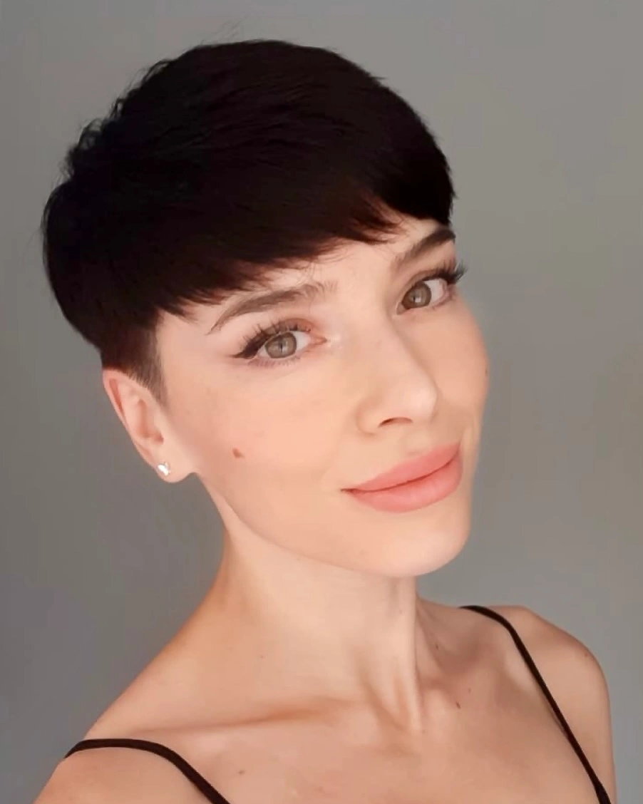 Short dark brown pixie-length cut with textured fringe