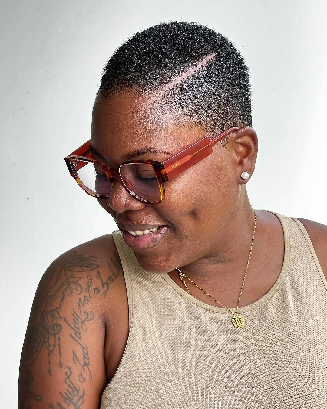 Very short close haircut with side line and glasses