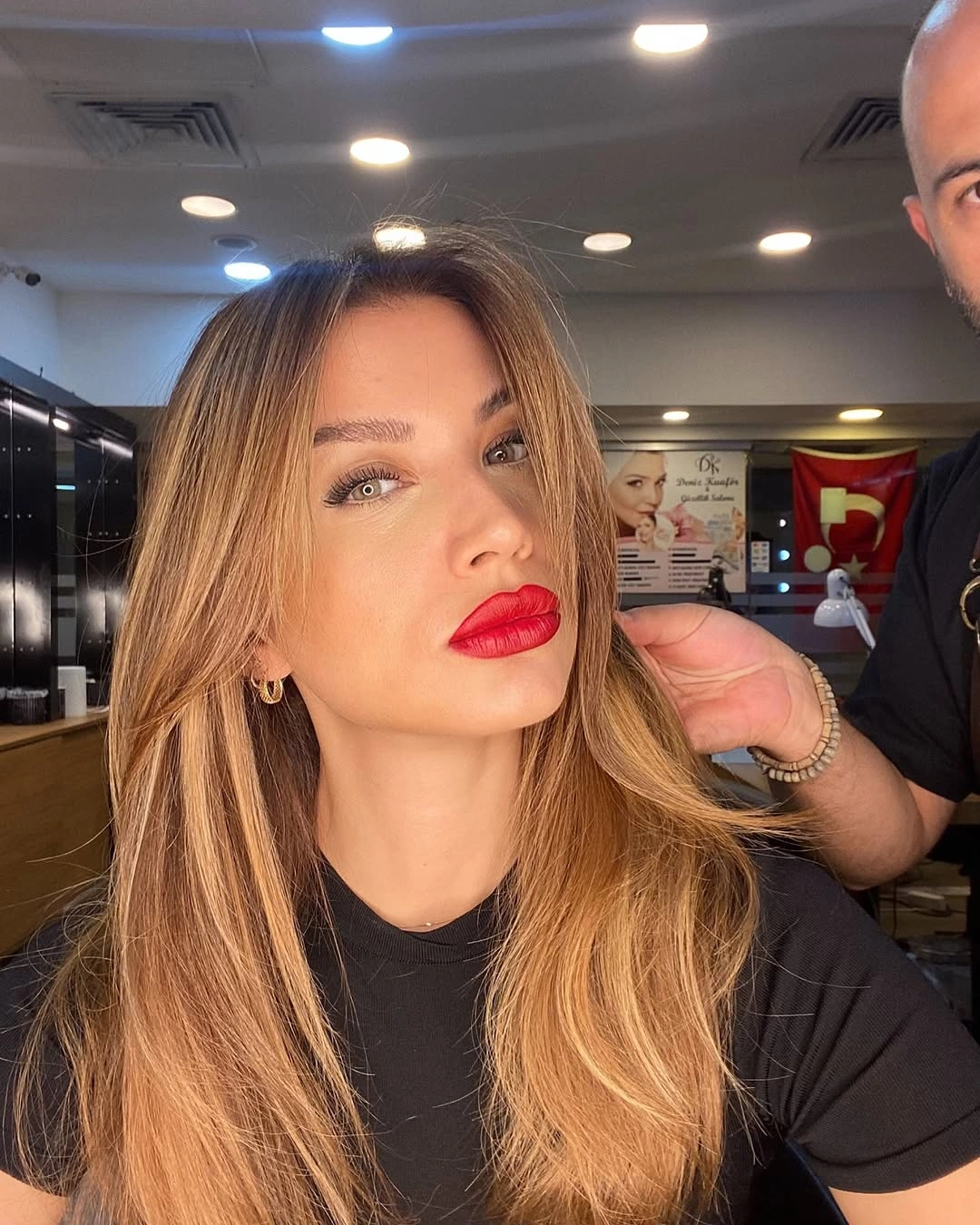Long warm blonde hair with center part and face-framing layers