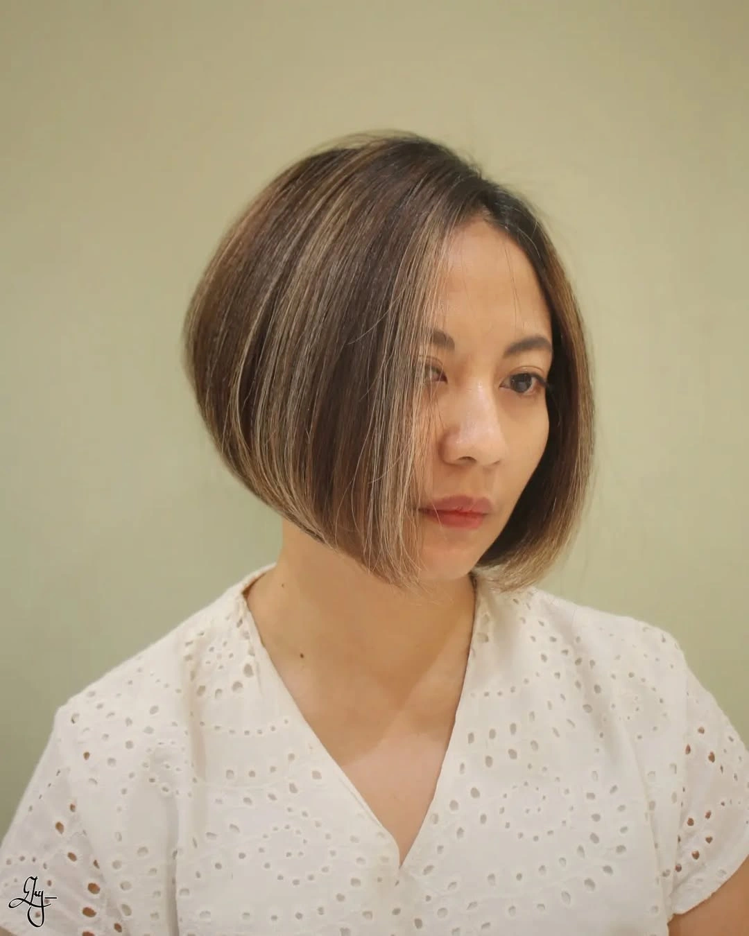 Sleek chin-length brunette bob with side part