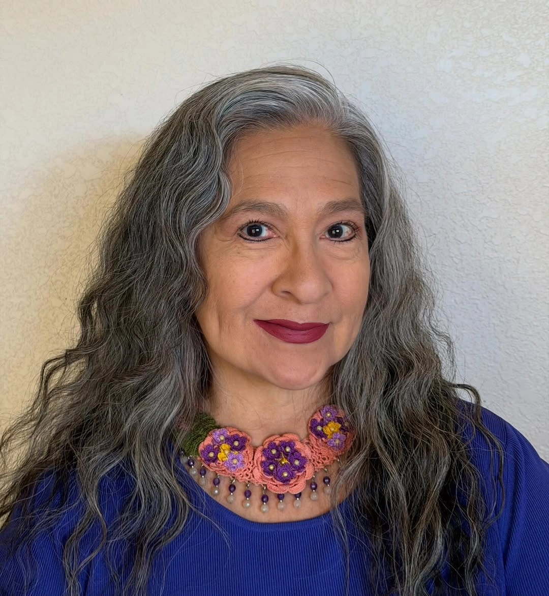 Long gray-silver hair with loose waves and layered-looking ends