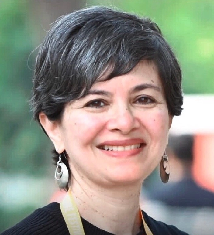 Short-to-medium dark-gray textured cut with side-swept front and earrings