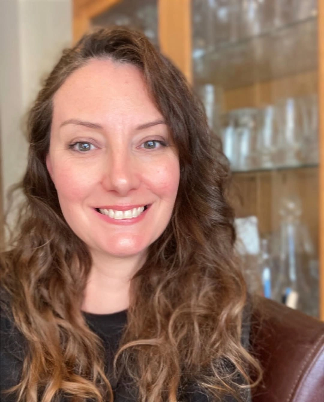 Long medium-brown hair with loose waves and soft side part