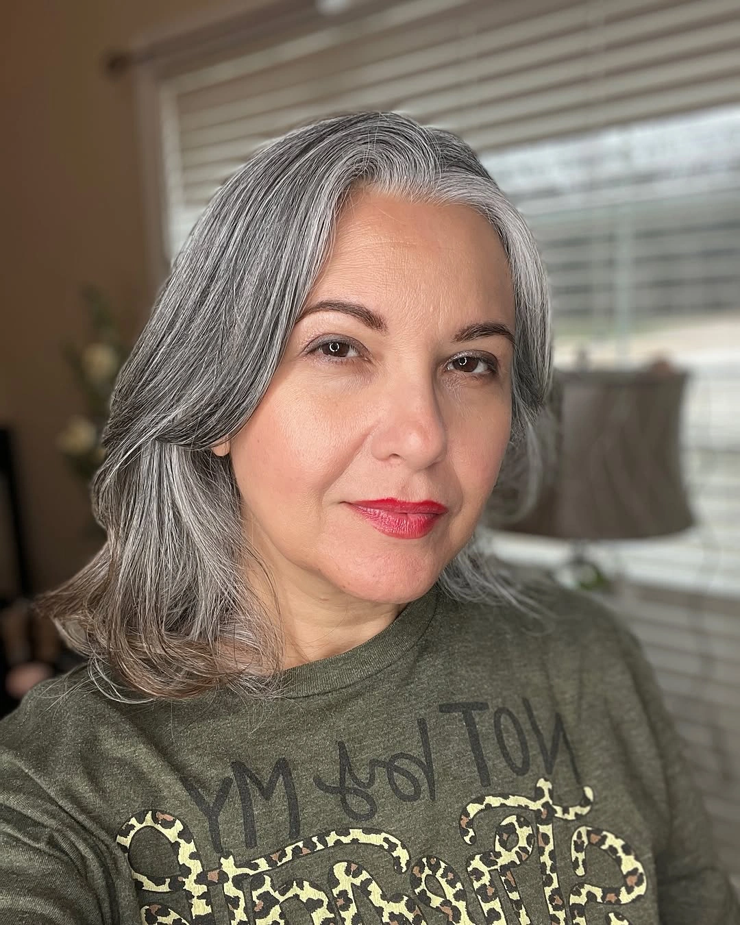 Medium silver-gray hair with loose waves and shoulder-length layered ends