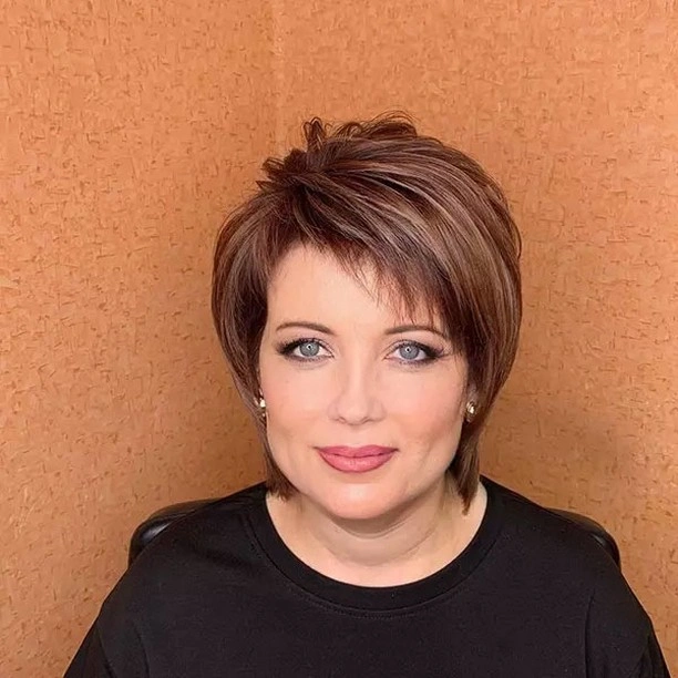 Short brown cut with side-swept fringe and tapered-looking nape