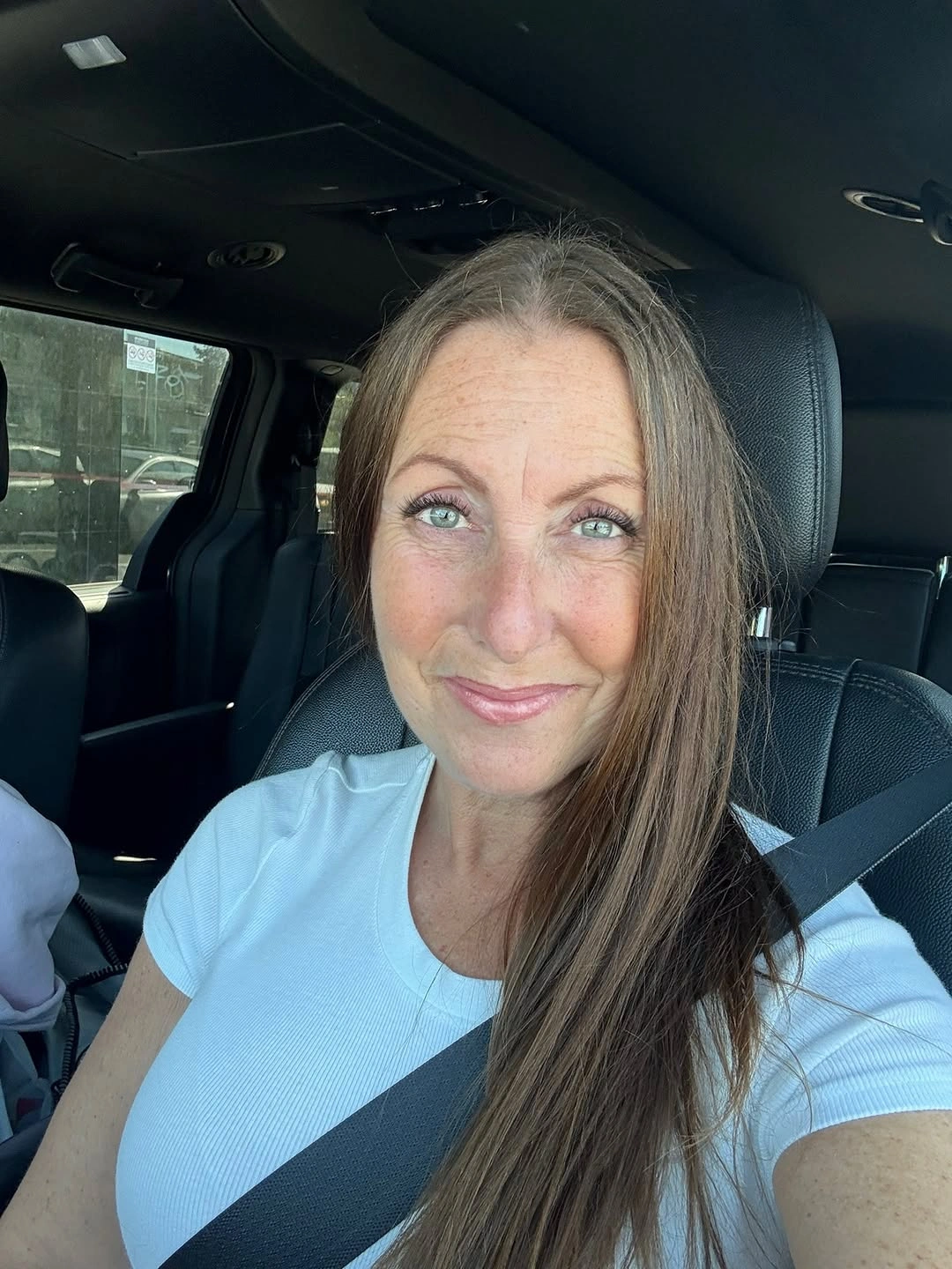 Long straight medium-brown hair with subtle side part