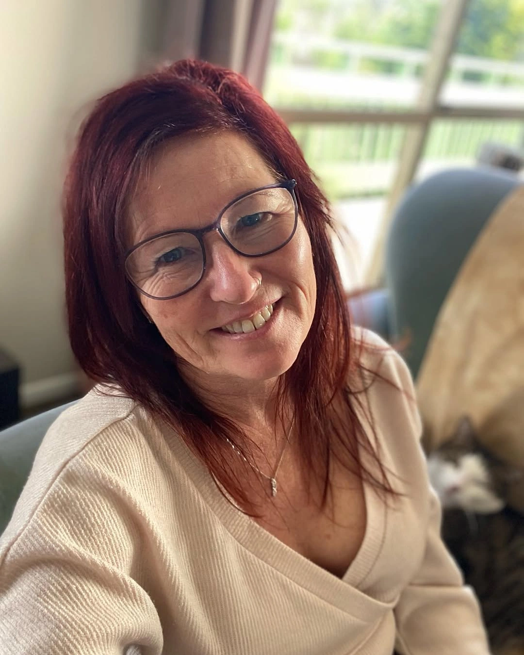 Medium auburn hair with side part, glasses, and bent shoulder ends