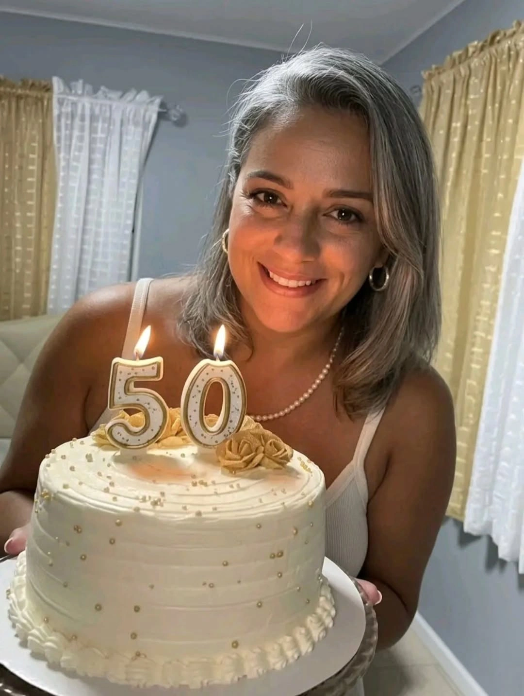 Medium gray side-parted waves beside cake with 50 candles
