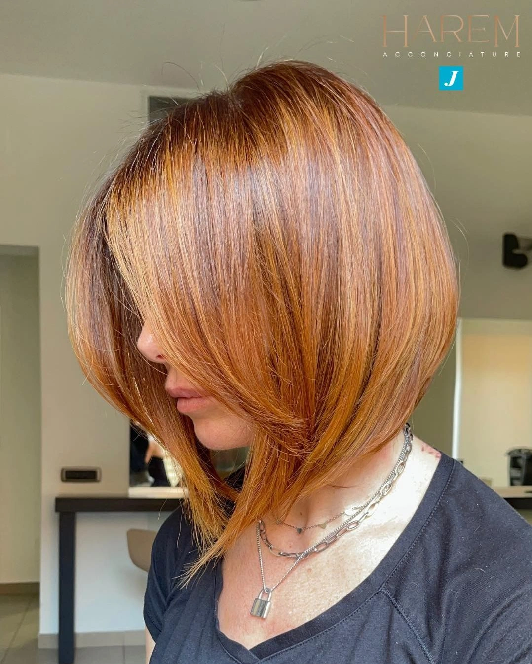 Medium-short copper hair with side sweep and curved ends