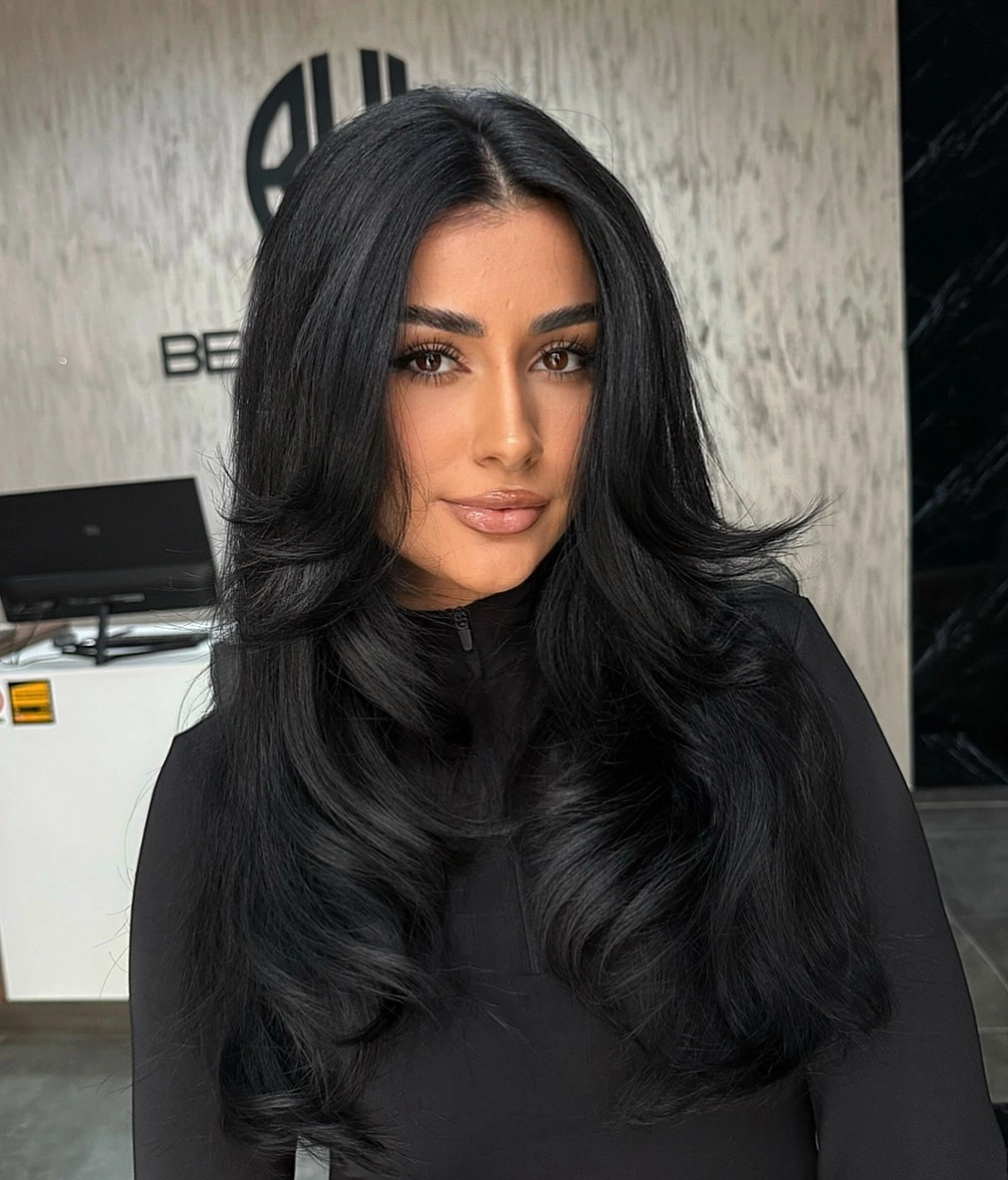 Long dark hair with center part and broad smooth waves