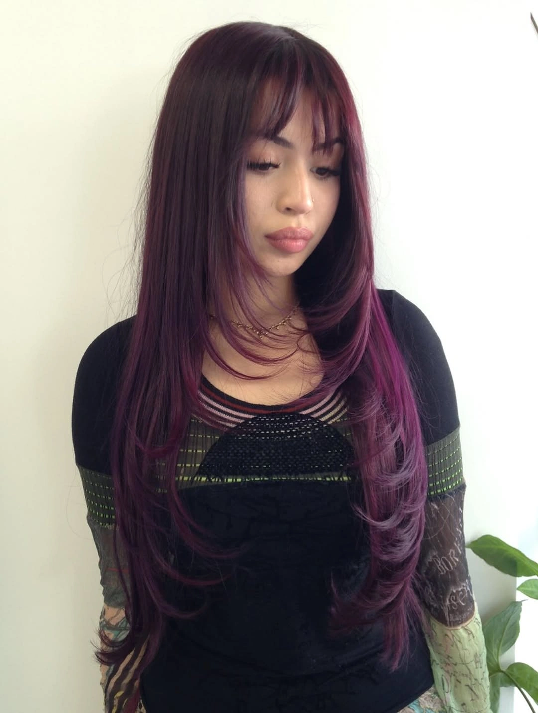 Long burgundy hair with wispy fringe and softly bent ends
