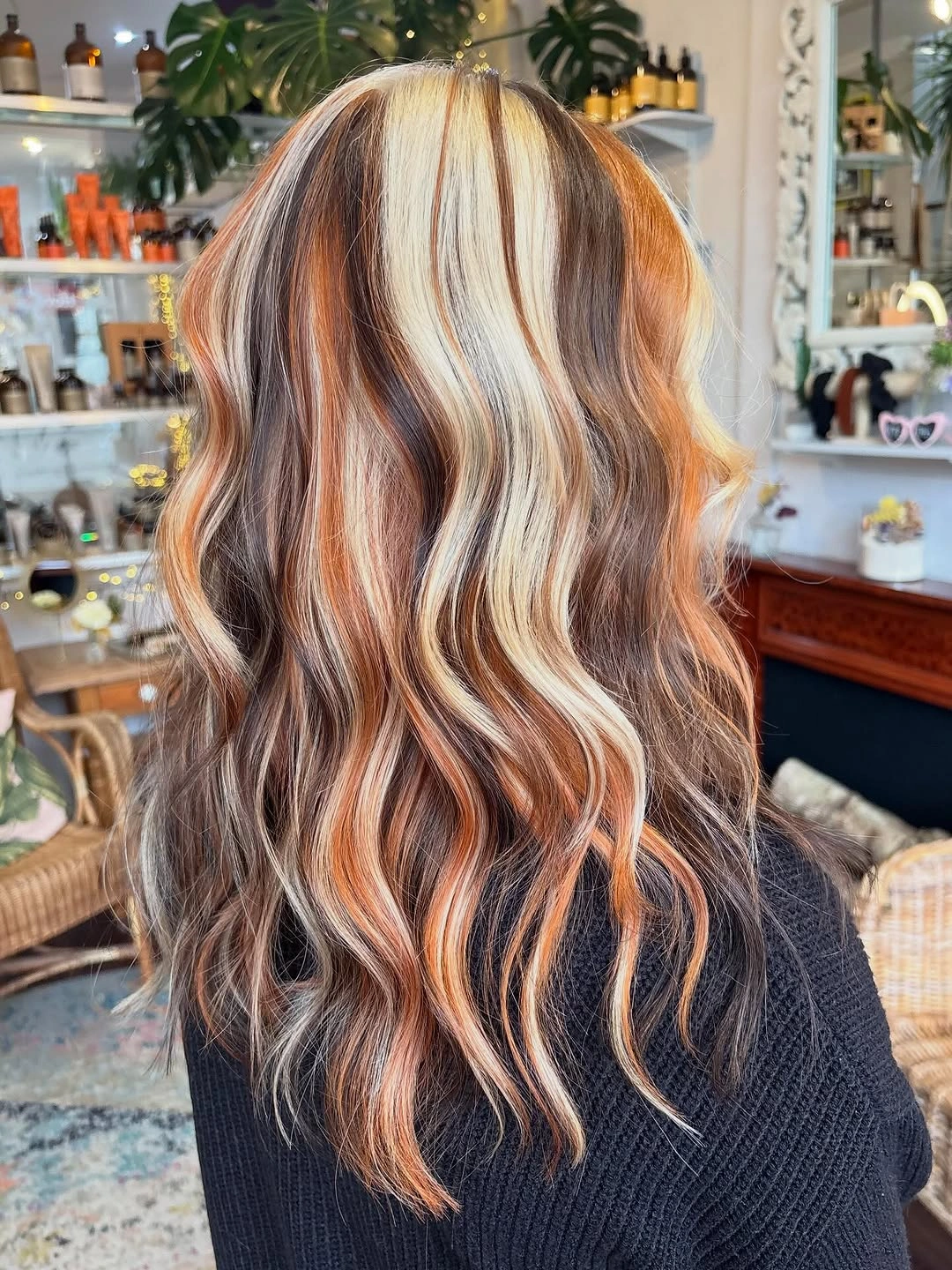 Long multitone hair with copper blonde brown sections and S-waves