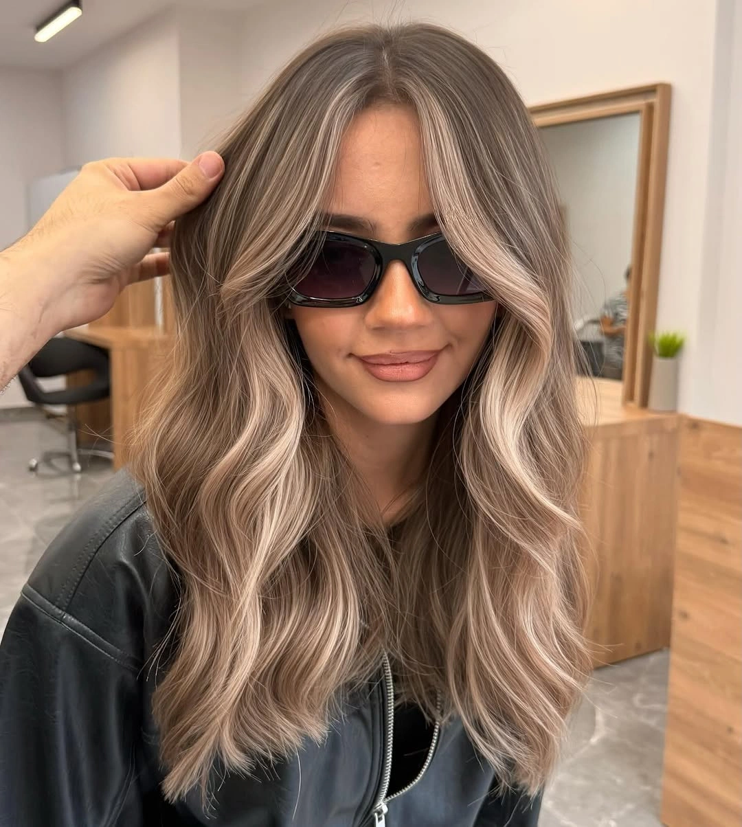 Ash-blonde hair with loose waves and lighter front pieces