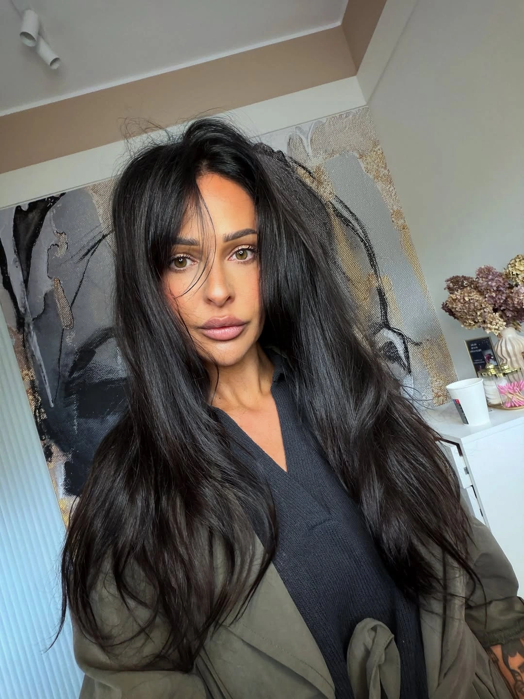 Long black hair with near-center part and loose lower waves
