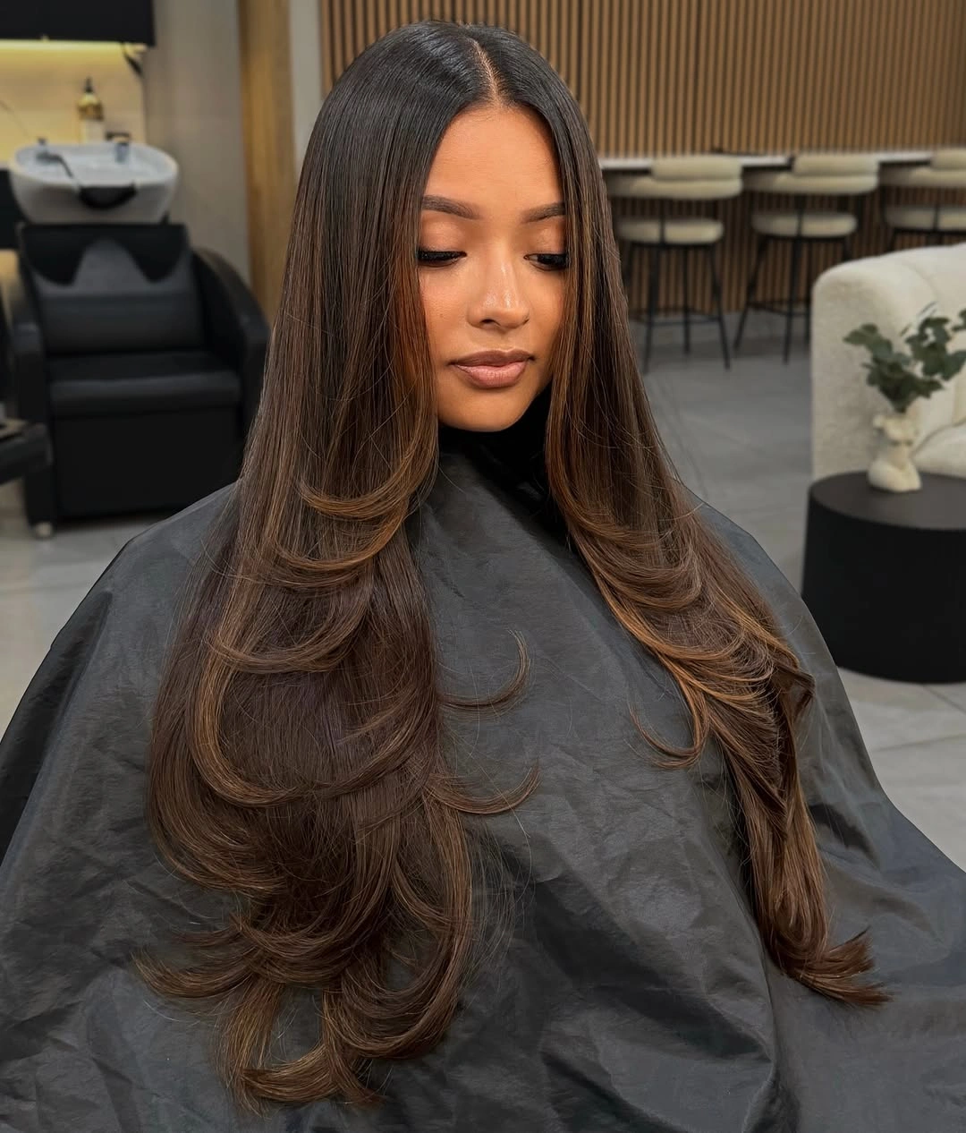 Very long brown hair with centered part and rounded lower curls
