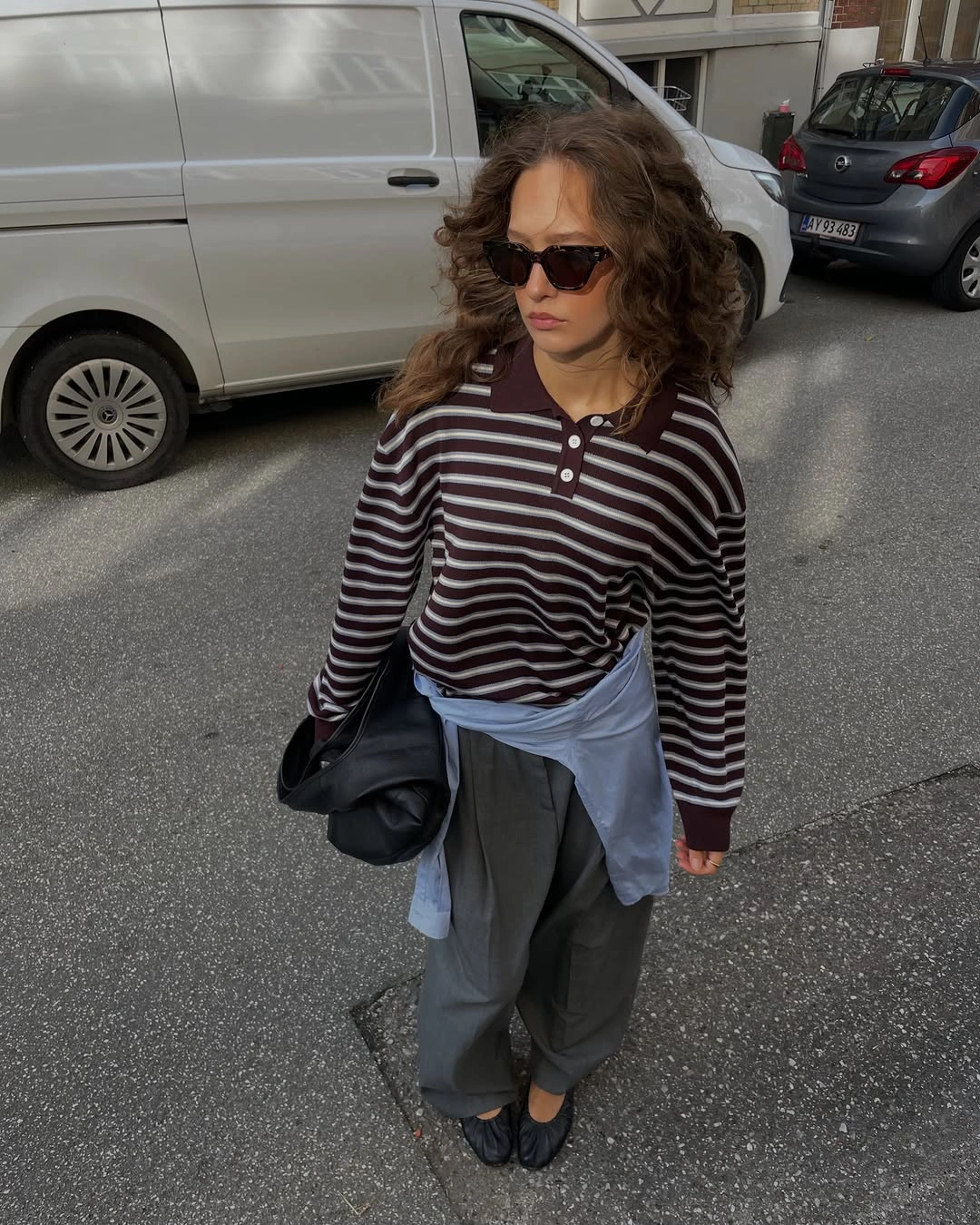 Maroon striped polo with tied blue shirt and gray trousers