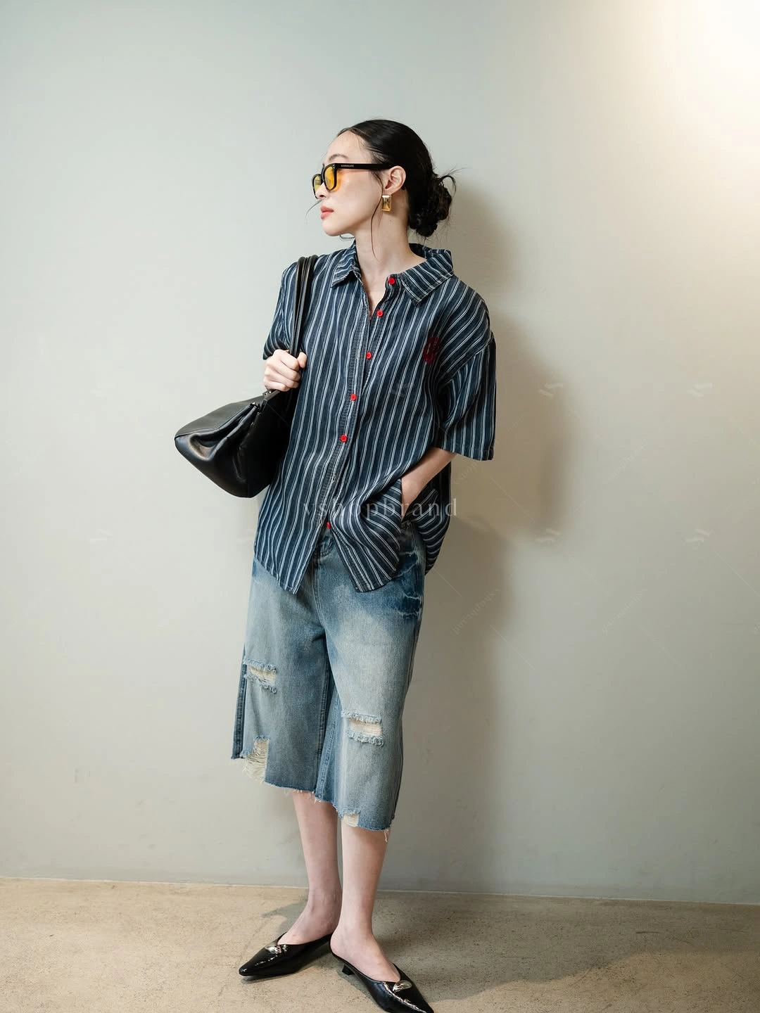 Dark striped shirt with distressed knee length denim and flats