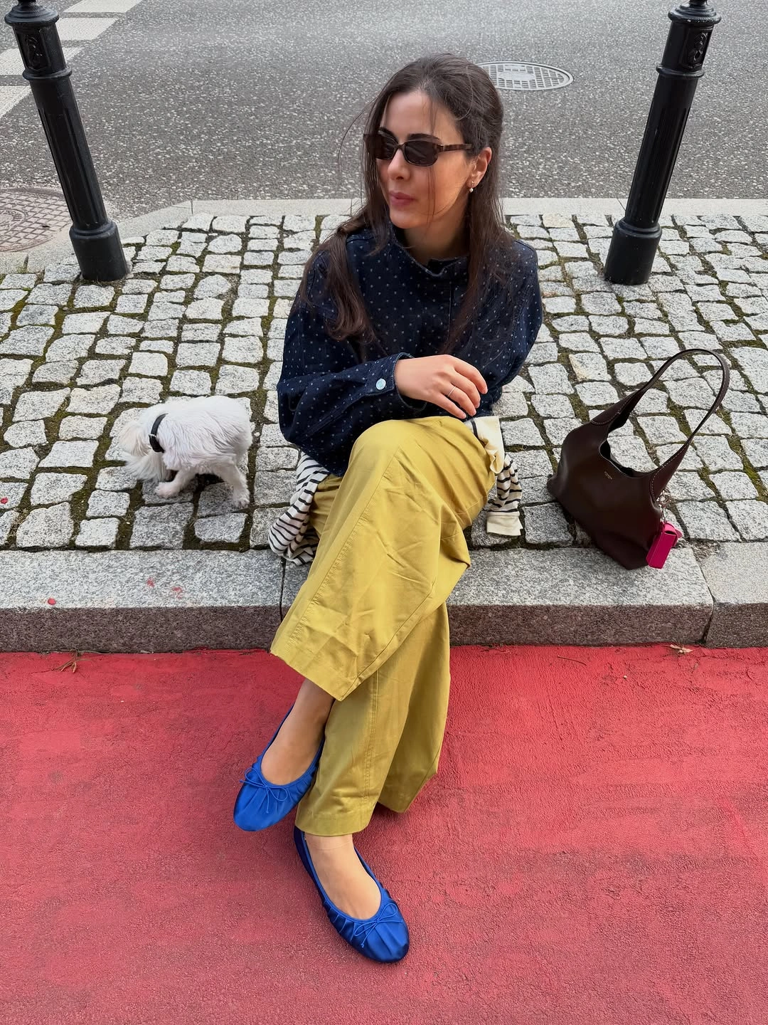 Dark dotted blouse with yellow trousers and blue flats