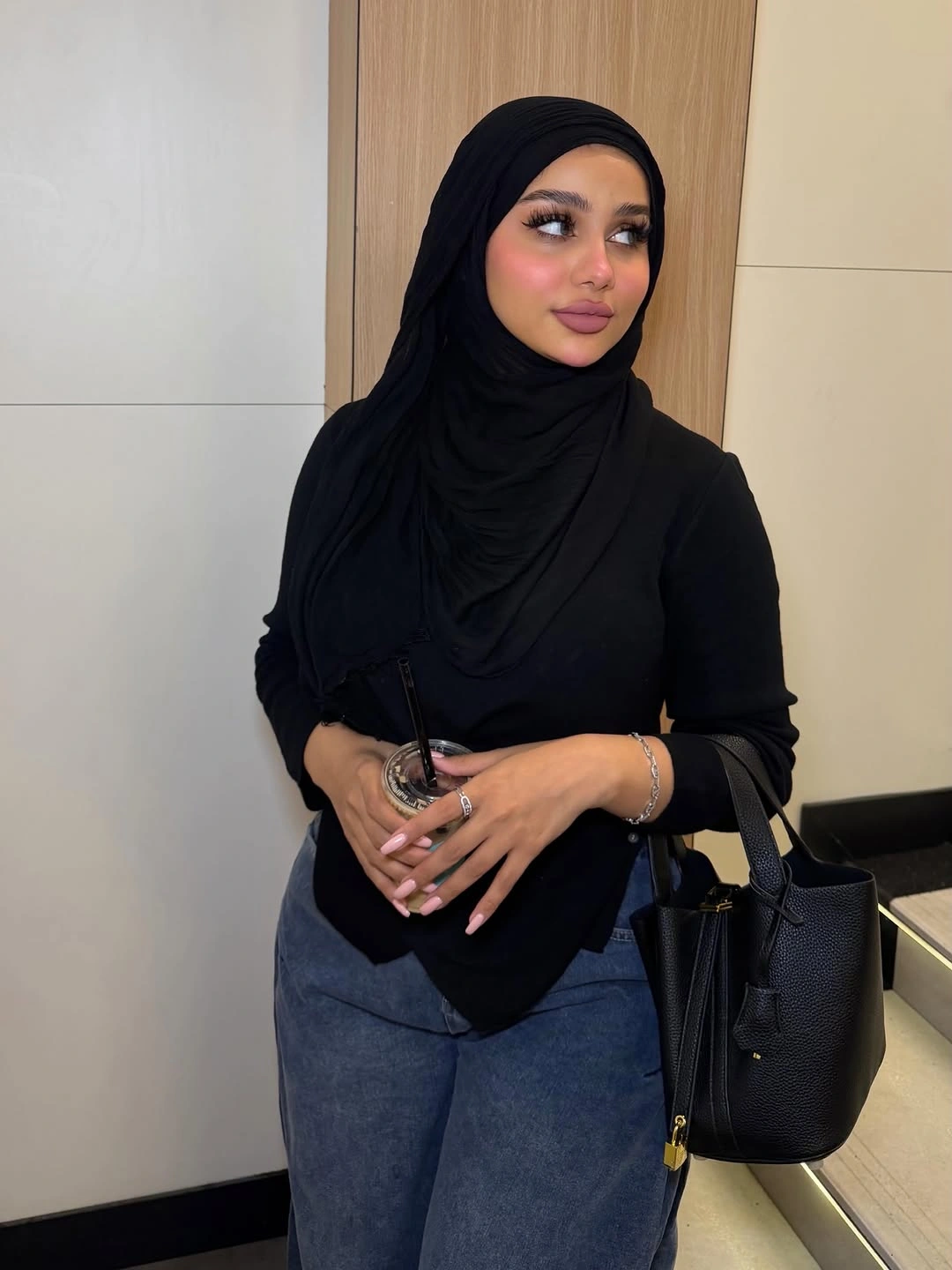 Black headscarf and top with dark wide jeans and tote