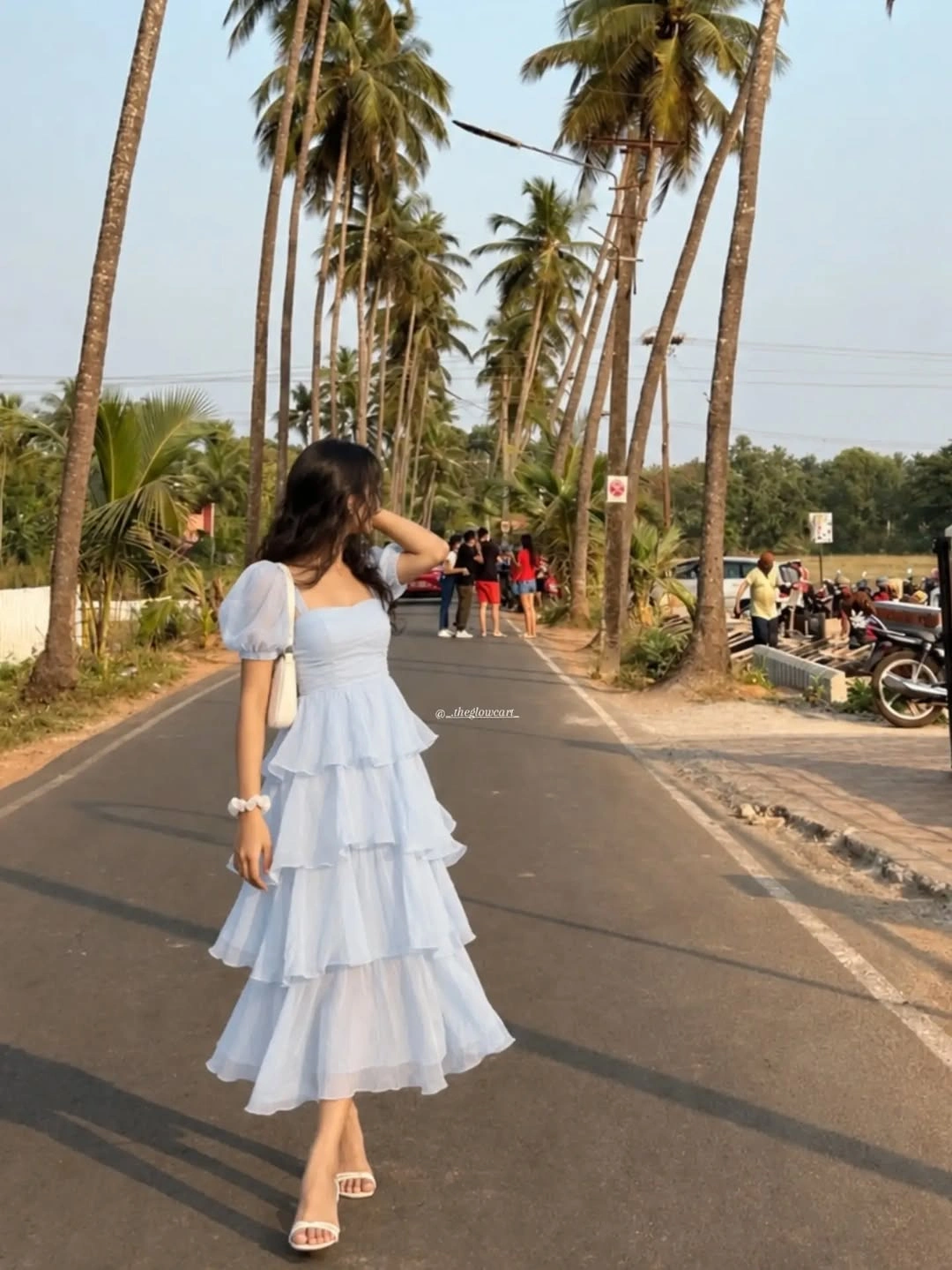 Pale blue tiered dress with white heeled sandals