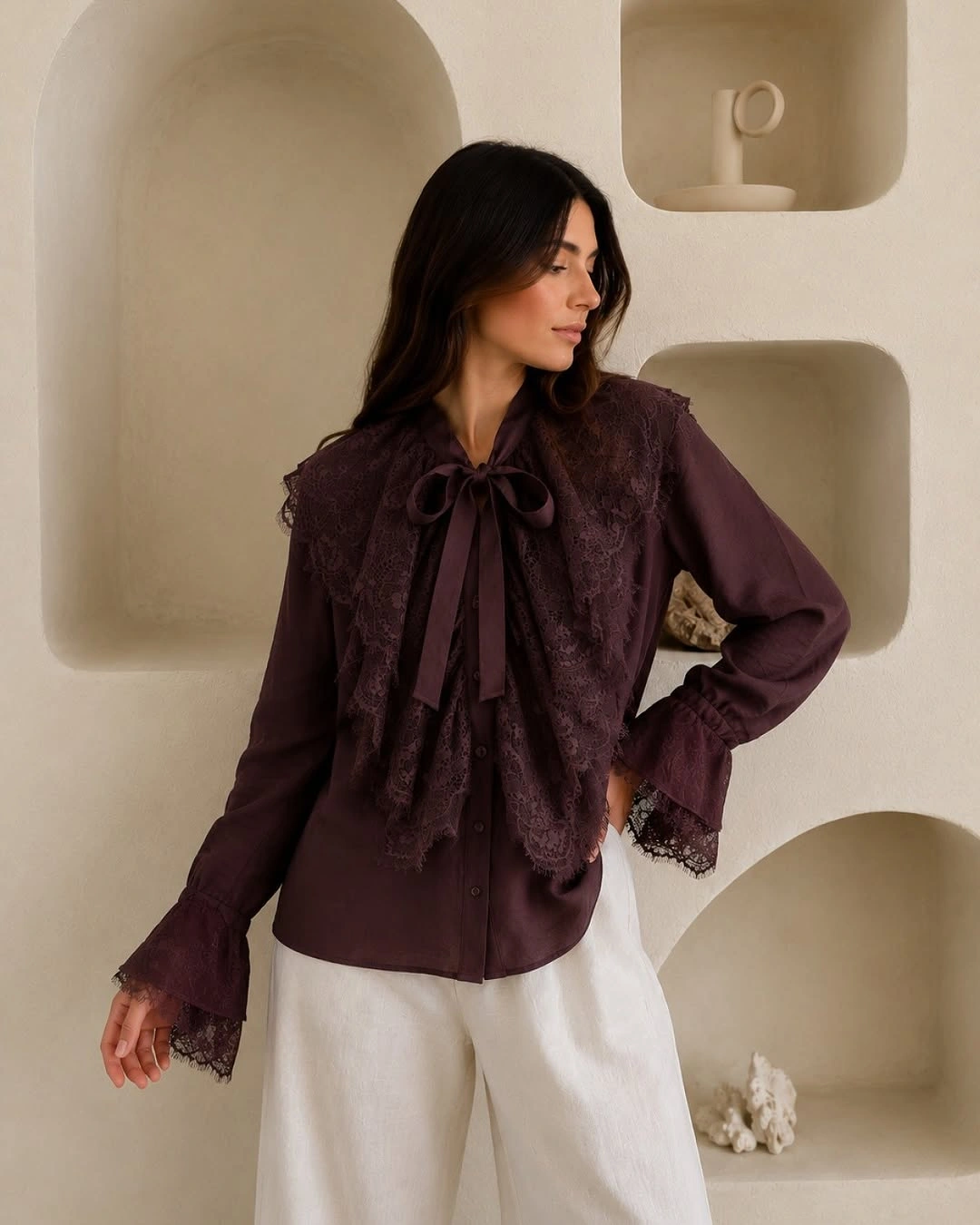 Burgundy bow blouse with lace panels and white trousers