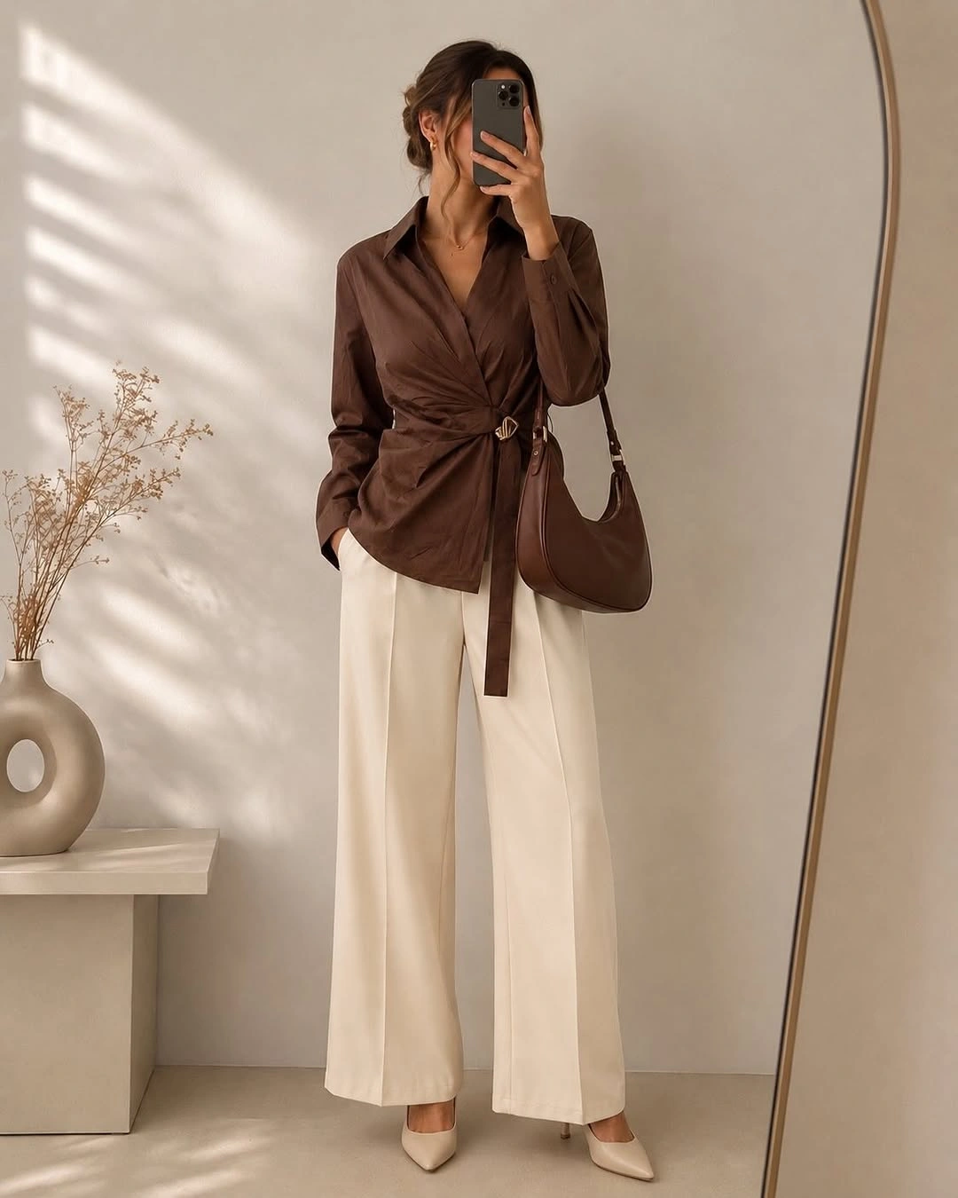 Brown wrap-style top with cream wide-leg trousers
