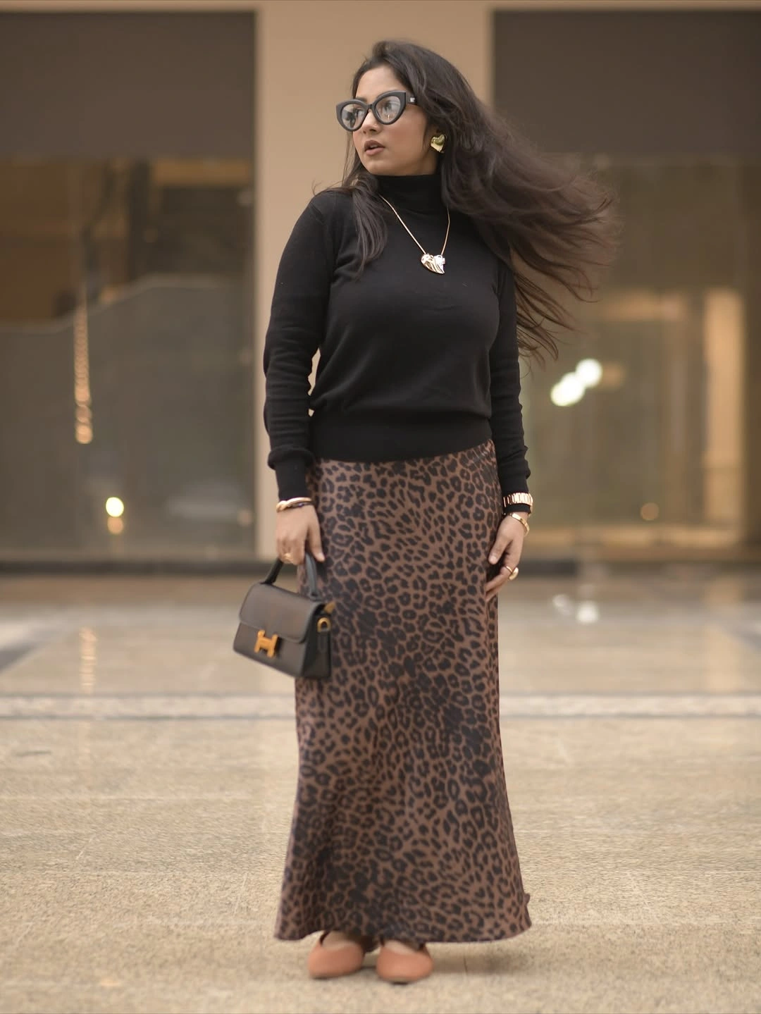 Black turtleneck with leopard skirt and tan flats