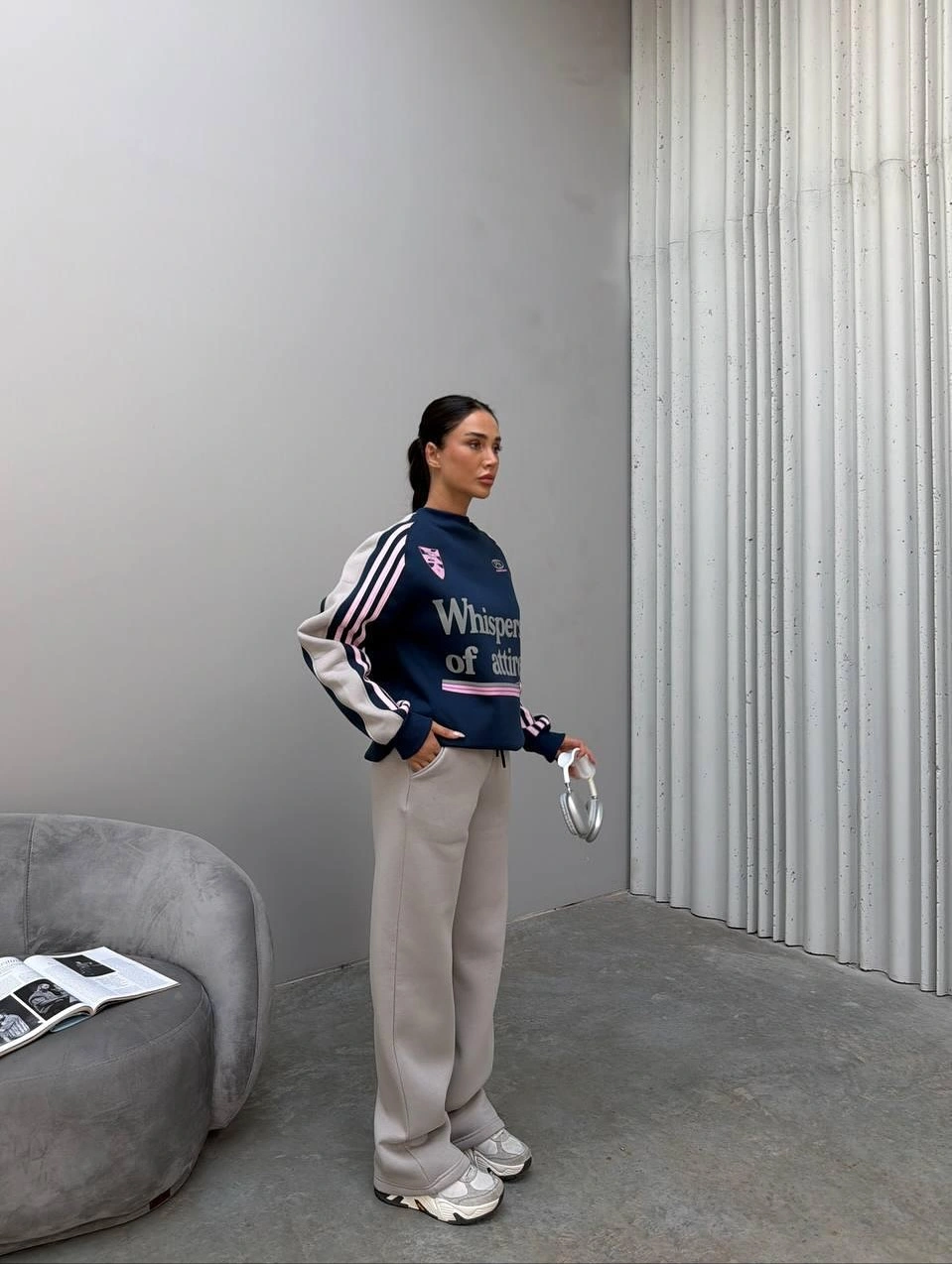 Navy graphic sweatshirt with pale trousers and sneakers