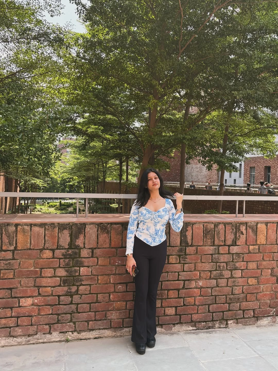 Blue and white printed top with black flared trousers