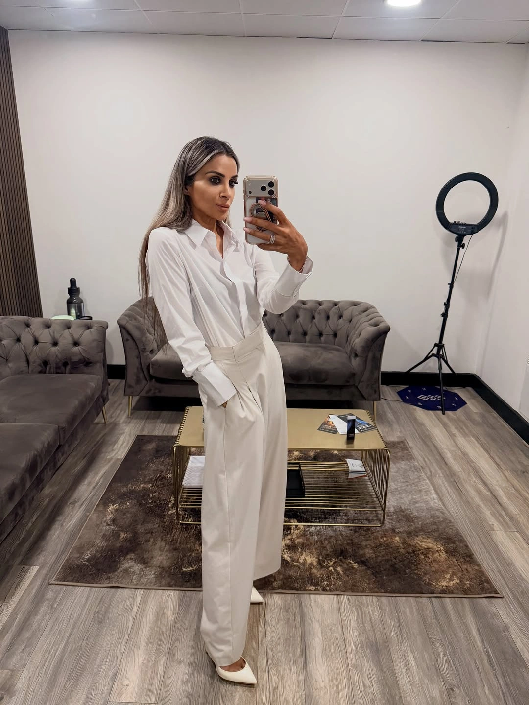 Woman in white button-up shirt and wide white trousers