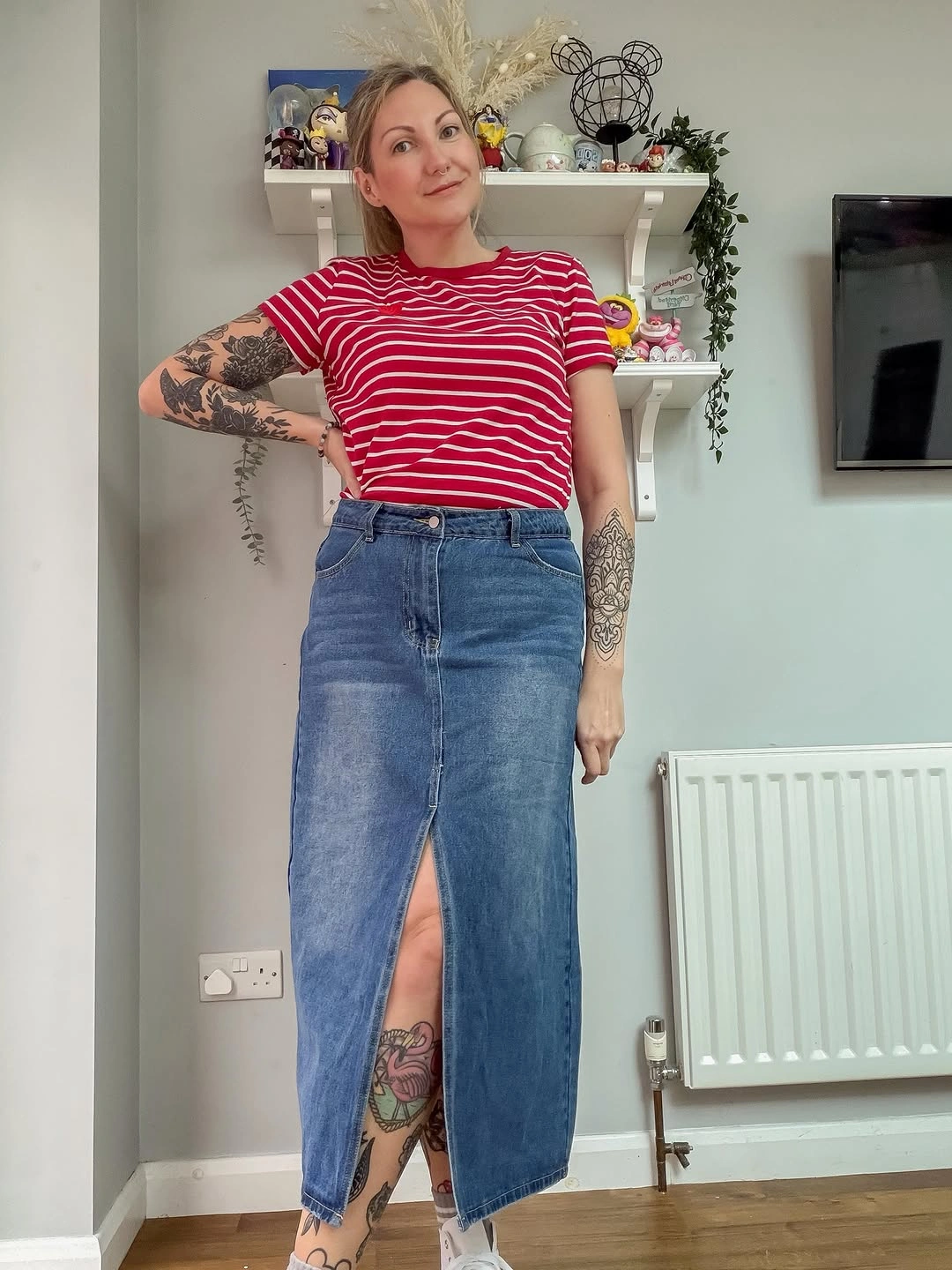 Woman in red striped tee and front slit denim skirt