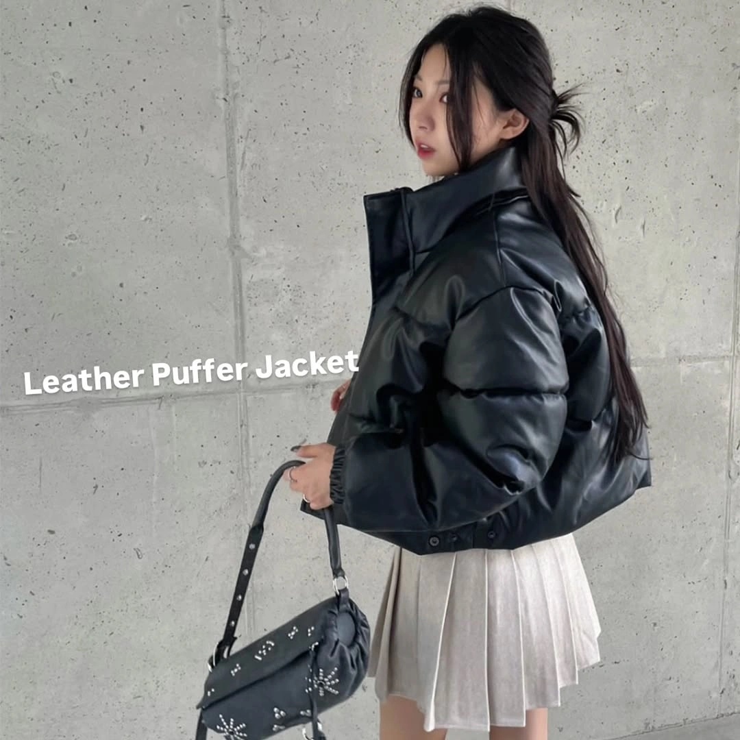 Glossy black cropped puffer with white pleated mini skirt