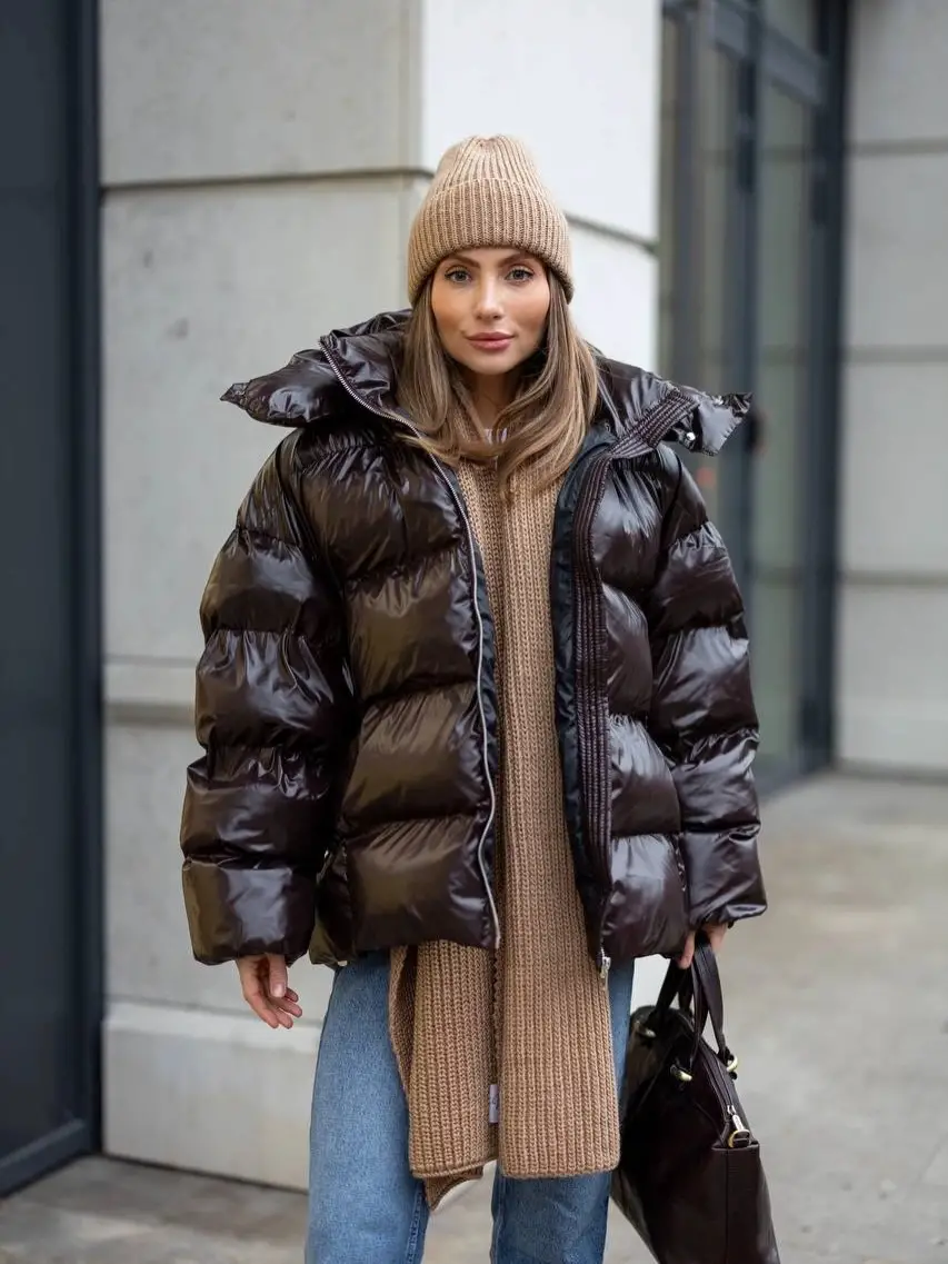 Glossy dark brown puffer with beige scarf, beanie, and jeans