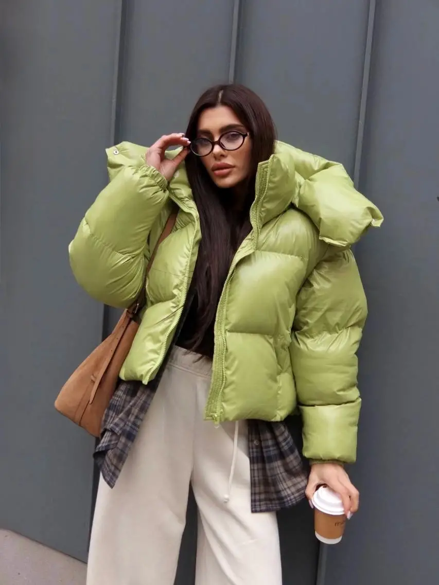 Light green puffer with cream trousers, plaid layer, and tan bag