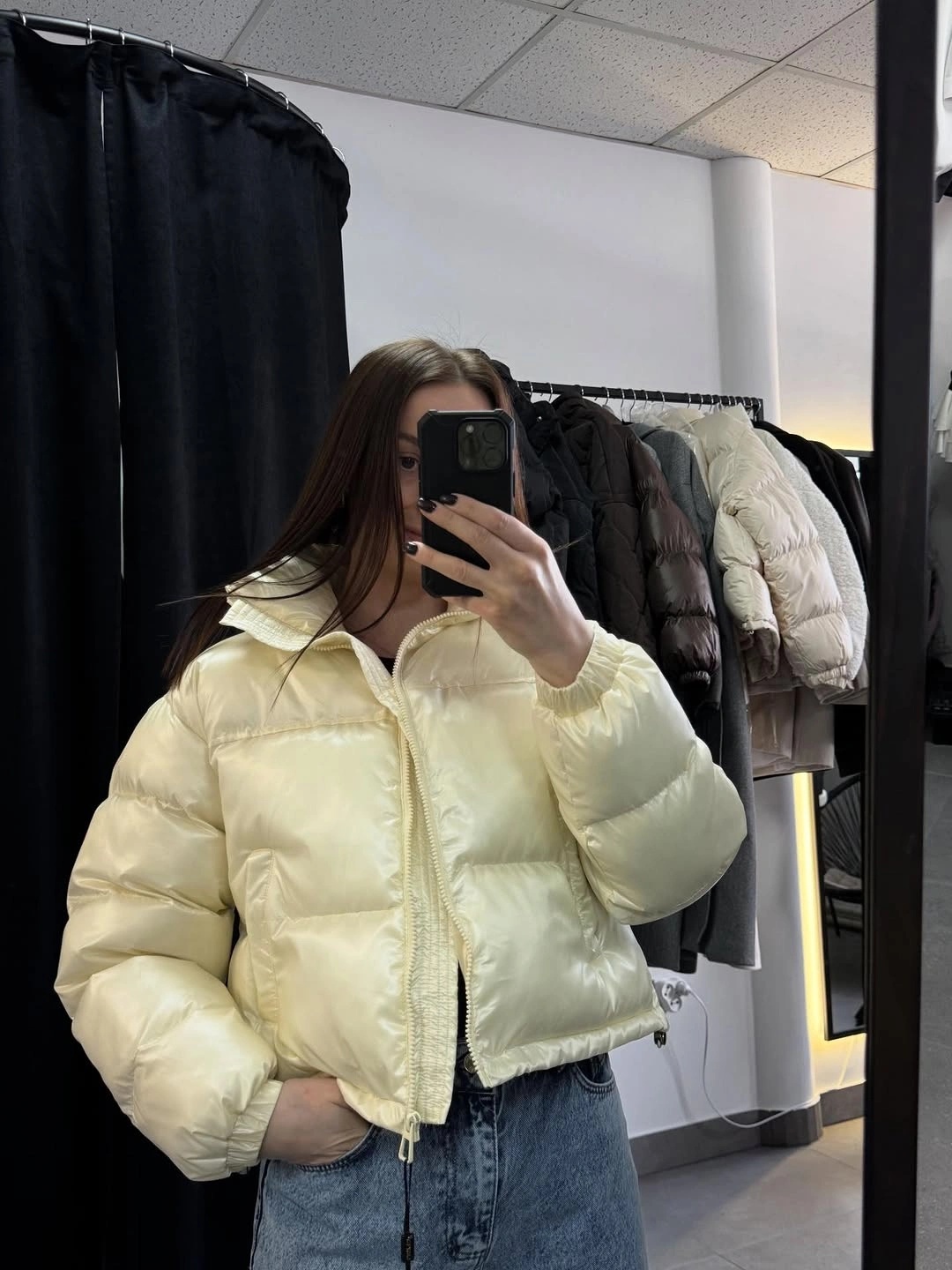Pale yellow cropped puffer with jeans in mirror selfie