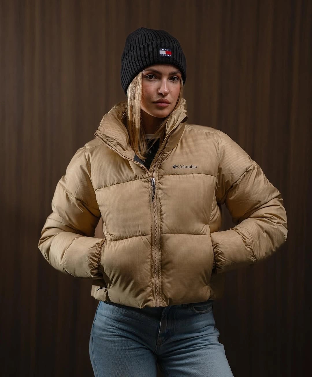 Tan cropped hooded puffer with black beanie and jeans