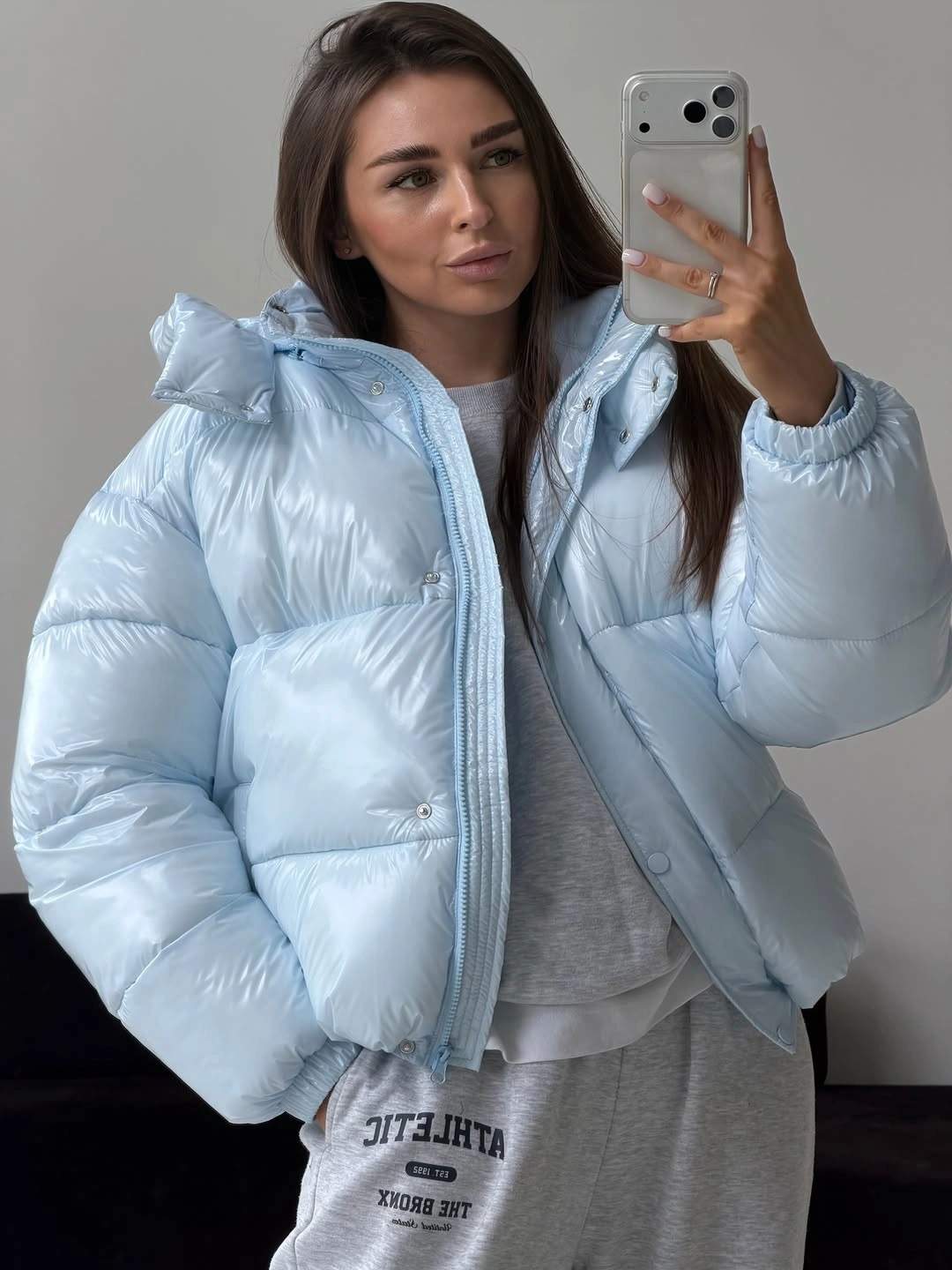 Glossy pale blue puffer with gray sweatshirt and sweatpants