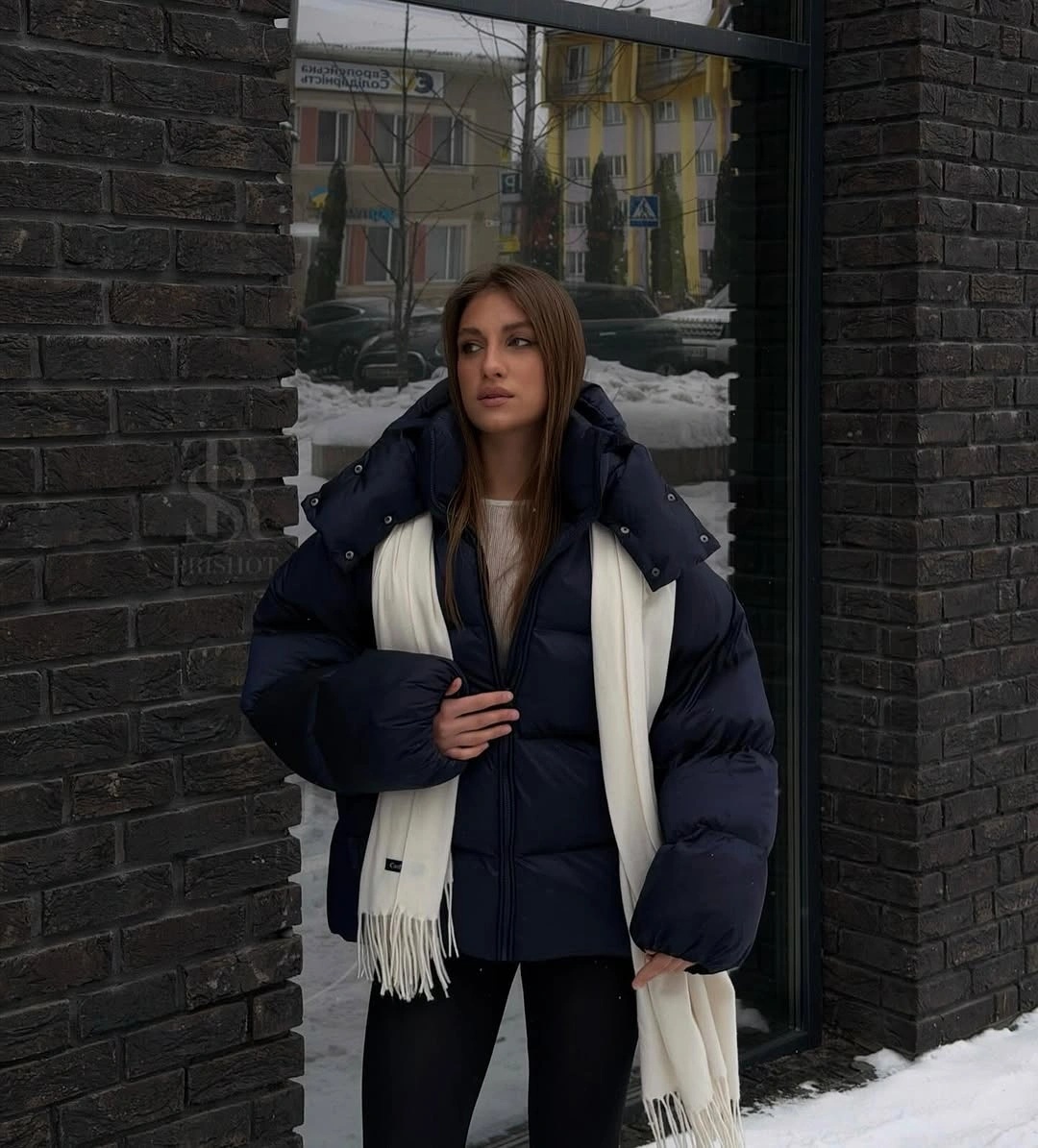 Very dark puffer with cream scarf and slim dark pants