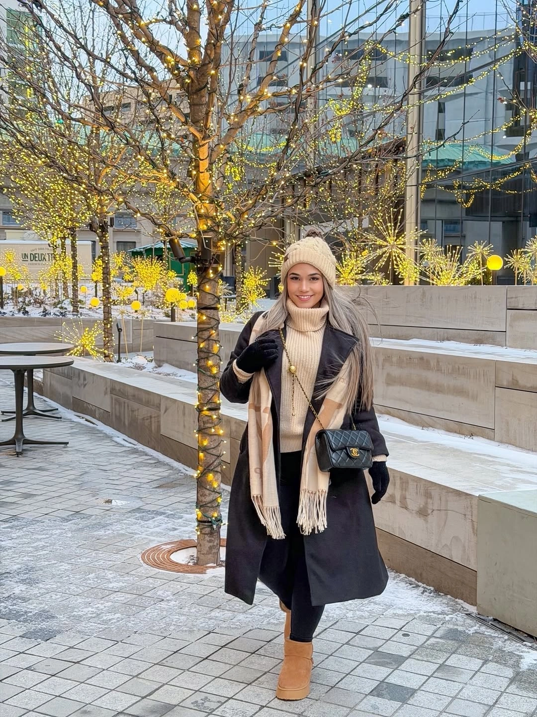 Dark coat with cream scarf beanie and tan ankle boots