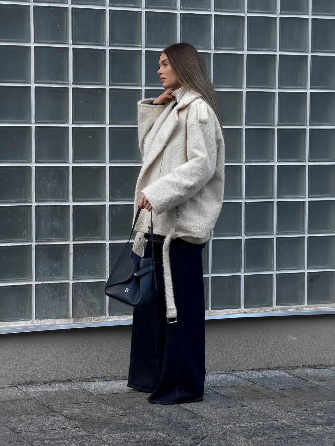 Light plush-textured belted jacket with dark wide trousers