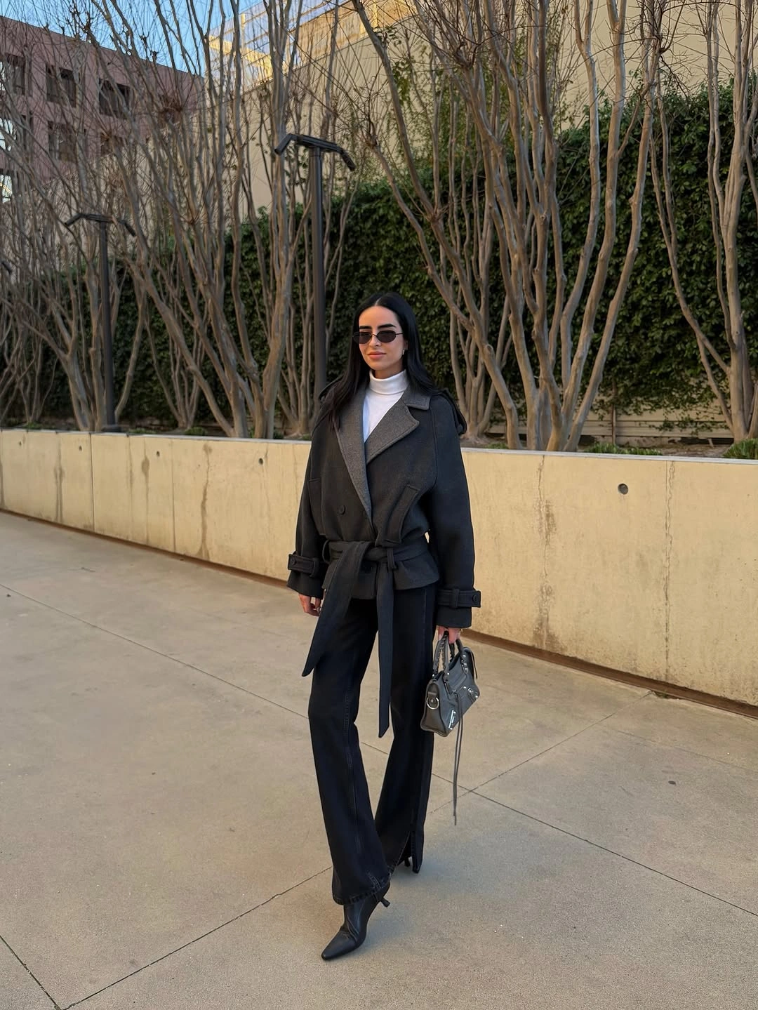 Belted black outer layer with white top and wide trousers