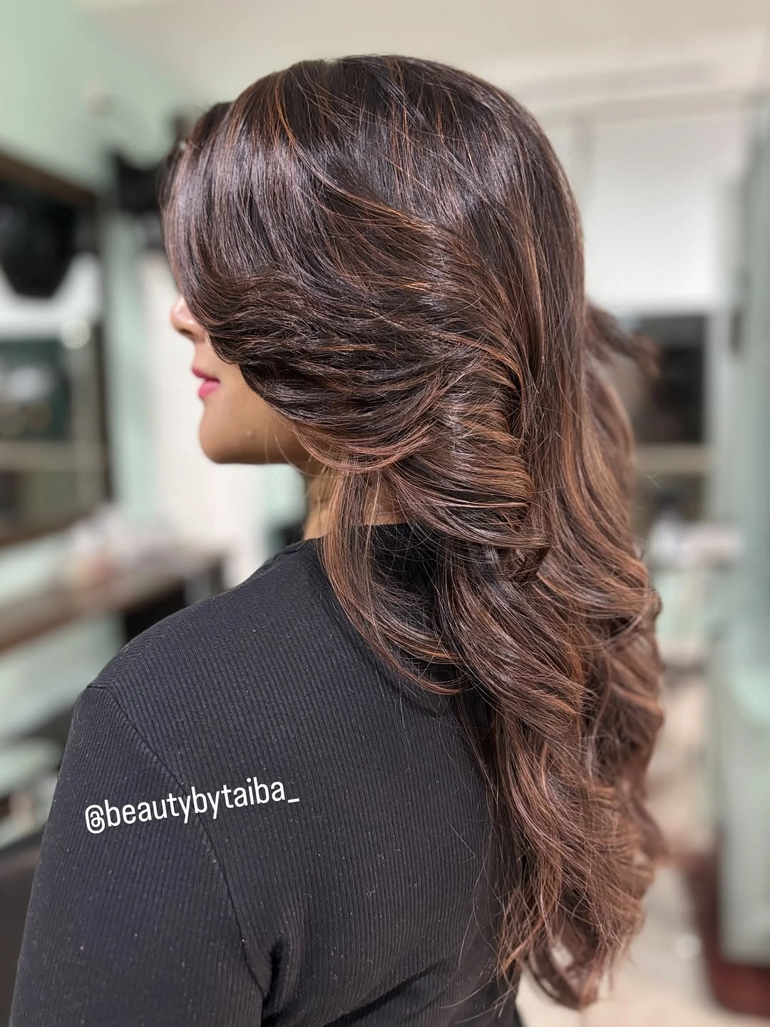 Long glossy chocolate brown hair with layered side sweep