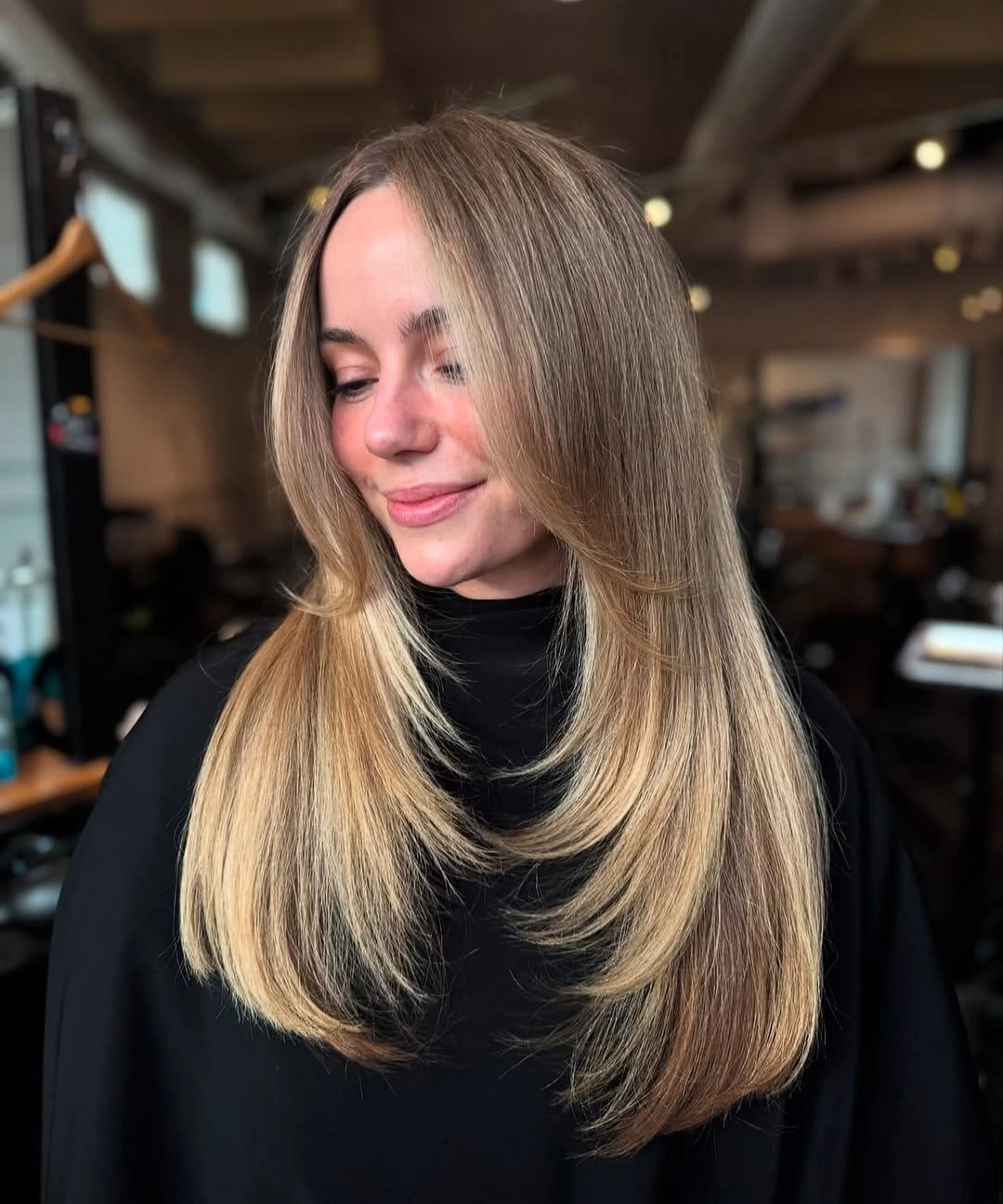 Pale beige blonde curls with dark contrasting ends from the back